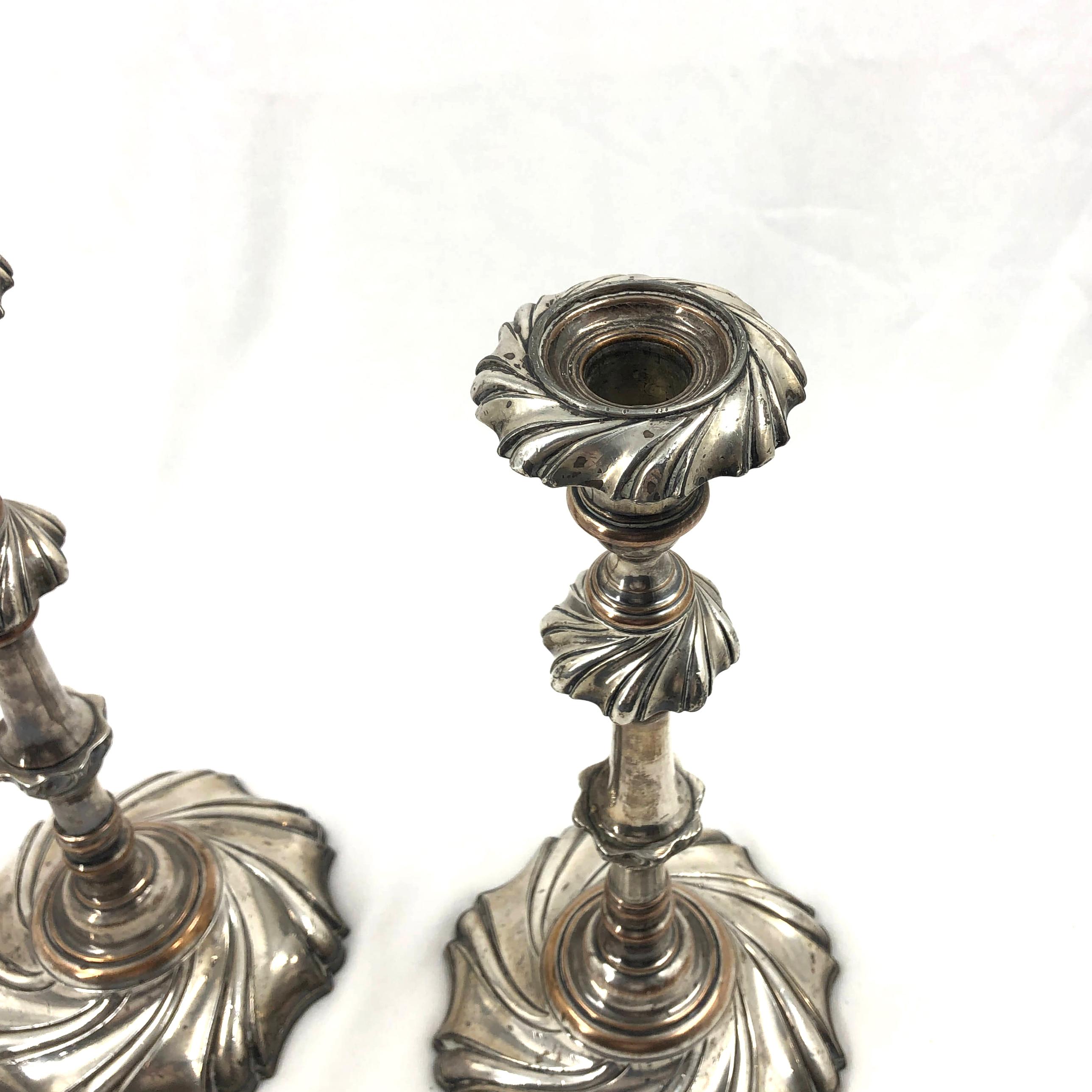 A pair of English Georgian silvered bronze swirl twisted candlesticks.