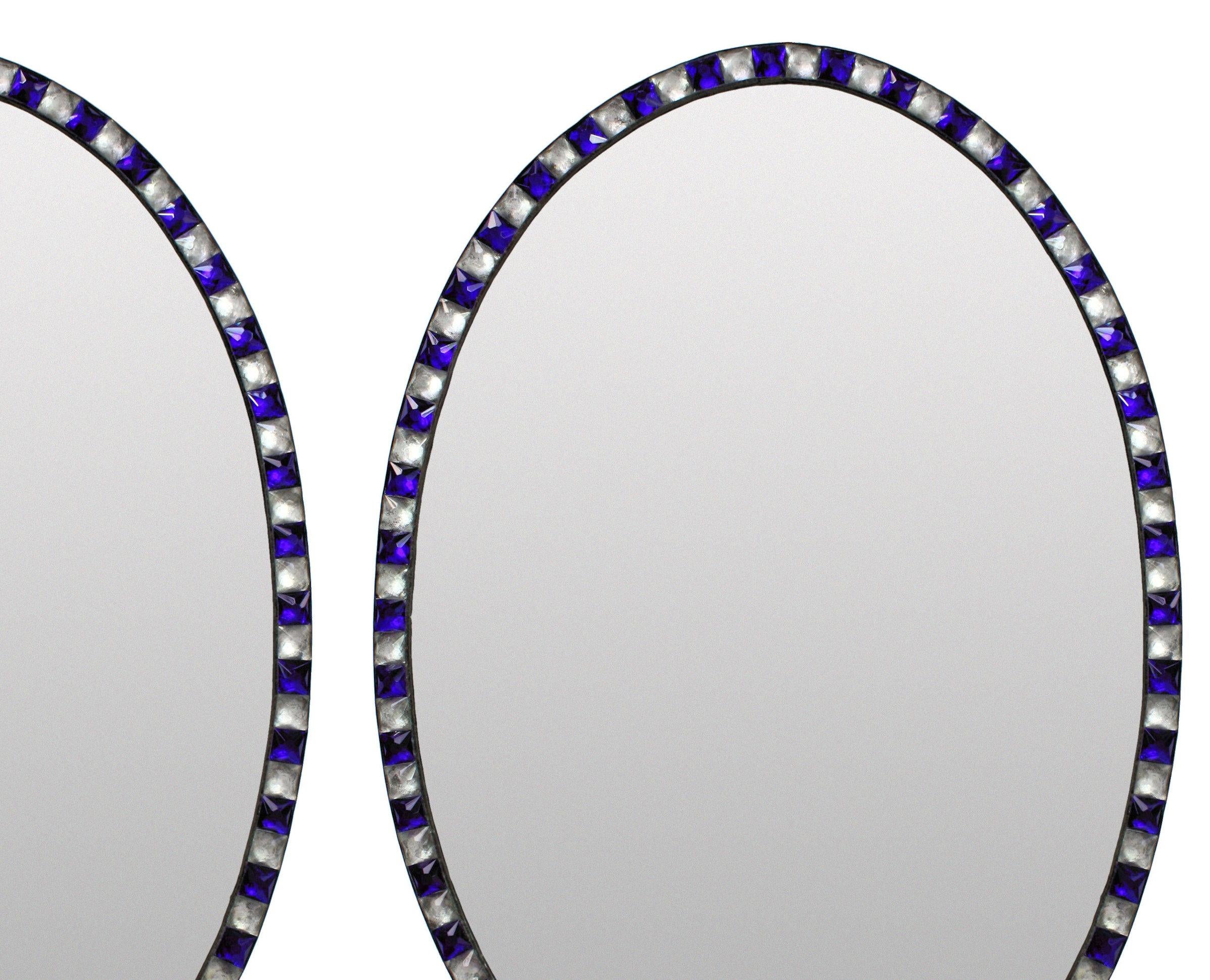 A pair of Irish mirrors in the George III style, of good quality with faux mercury glass mirror plates pinned into patinated copper frames, bordered with rock crystal and blue glass faceted studs in the traditional XVIII Century manner. Of good