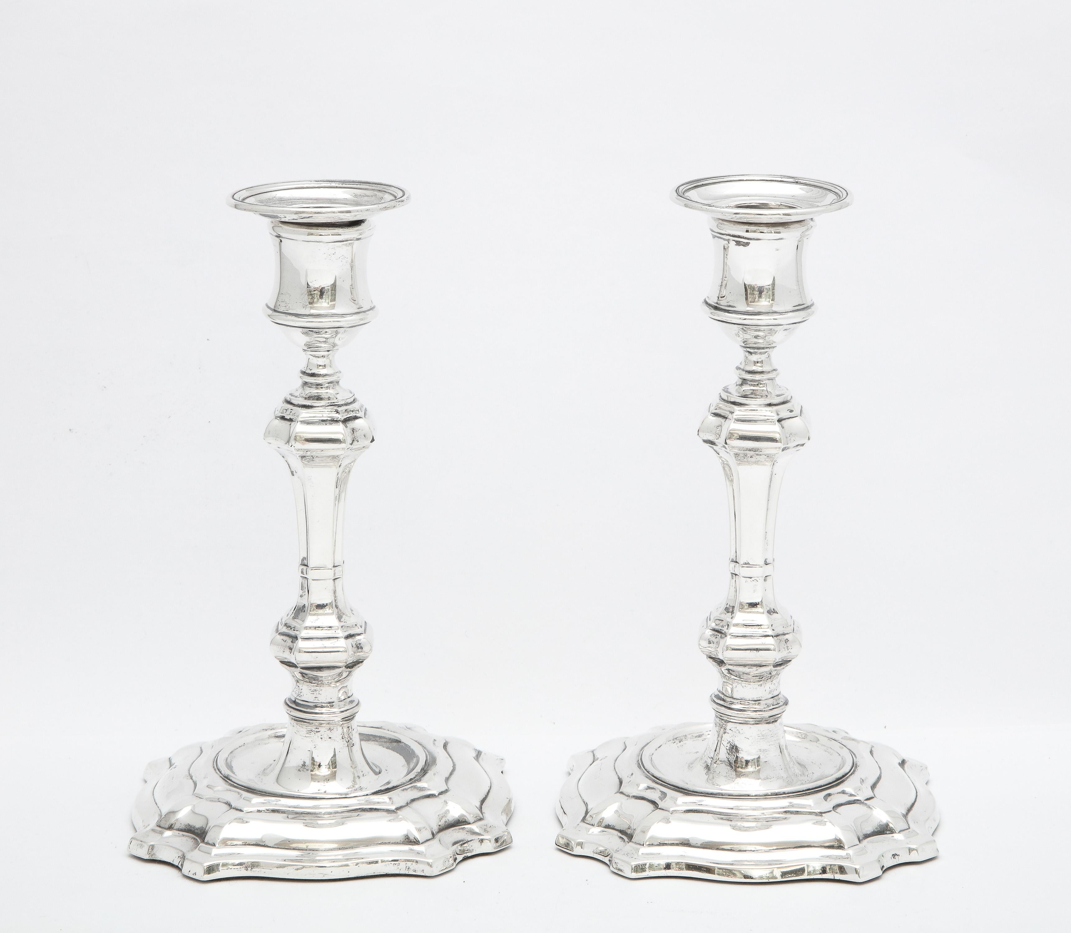 Pair of Georgian-style (George II-Style), sterling silver candlesticks, London, year-hallmarked for 1900, William Hutton and Sons - makers. Each candlestick measures 7 1/2 inches high x 4 inches deep (at deepest point) x 4 inches wide (at widest