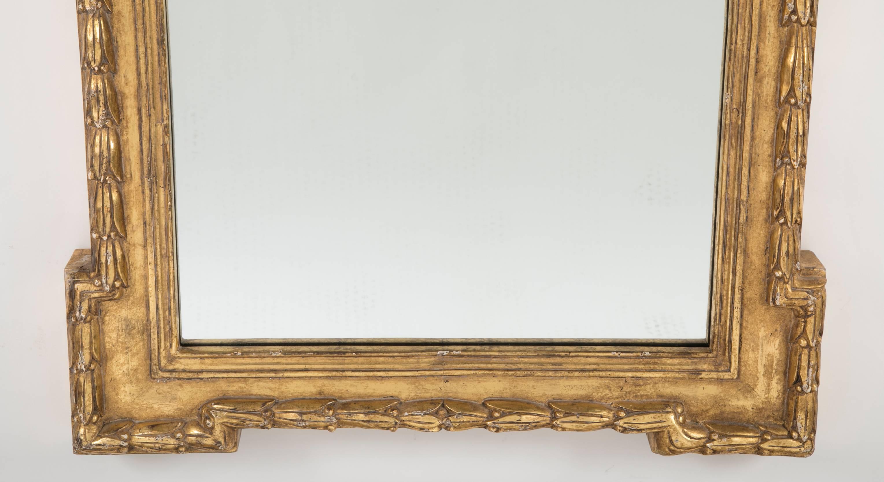 A early 20th century pair of water gilt Georgian style mirrors with exceptional carving.