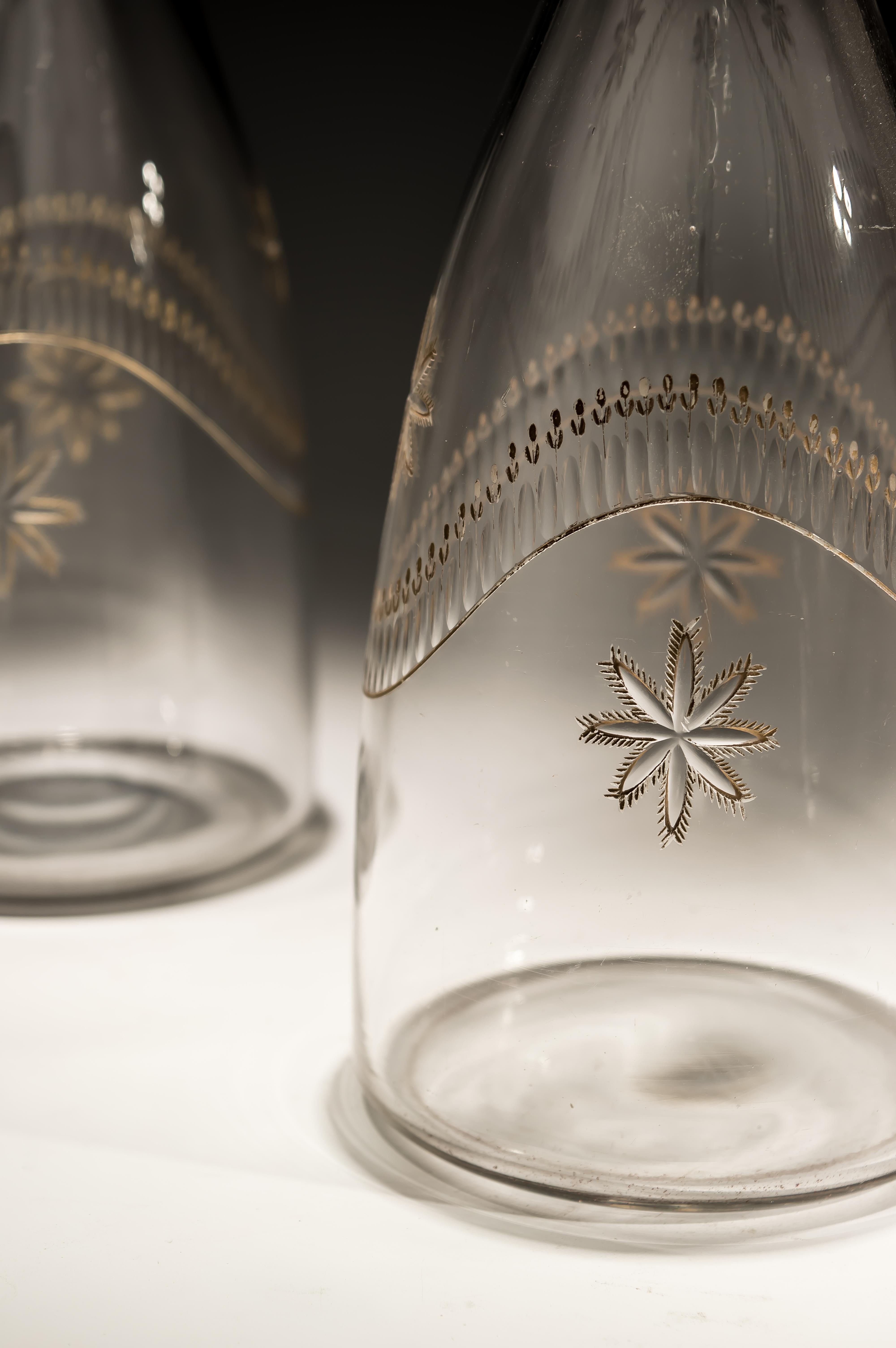 Pair of Georgian taper decanters engraved with gilded swags of tulips and stars.