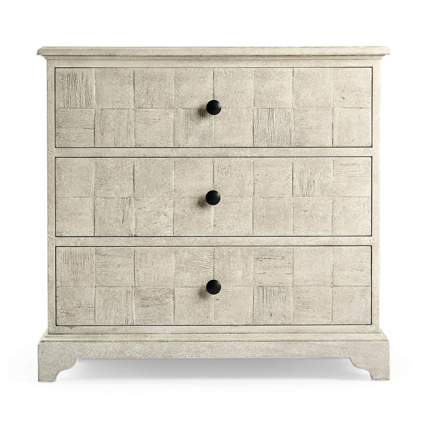 A pair of English Georgian style whitewash finish three-drawer chests of drawers with a molded edge top, crosshatched pattern drawer fronts on a stepped bracket foot base.

Dimensions: 31.75