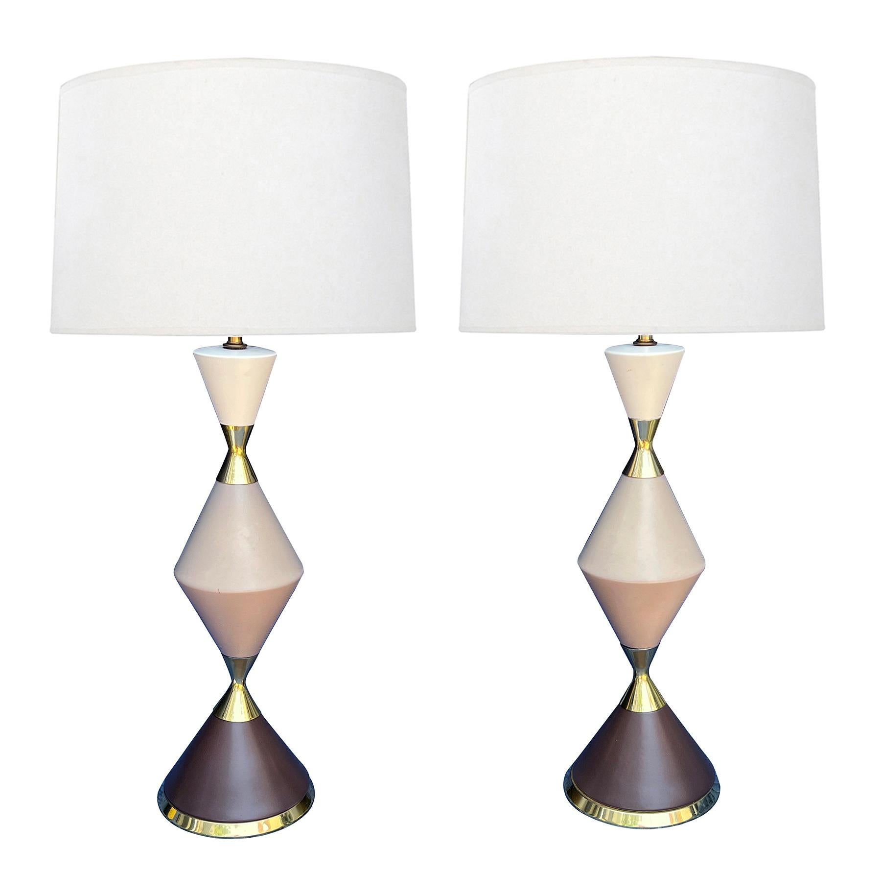 the best of post-war design, each lamp composed of stacked tri-color conical-form glazed elements with brass mounts; Gerald Thurston was one of the most creative American lighting designers of the postwar era. His innovative designs exemplify the