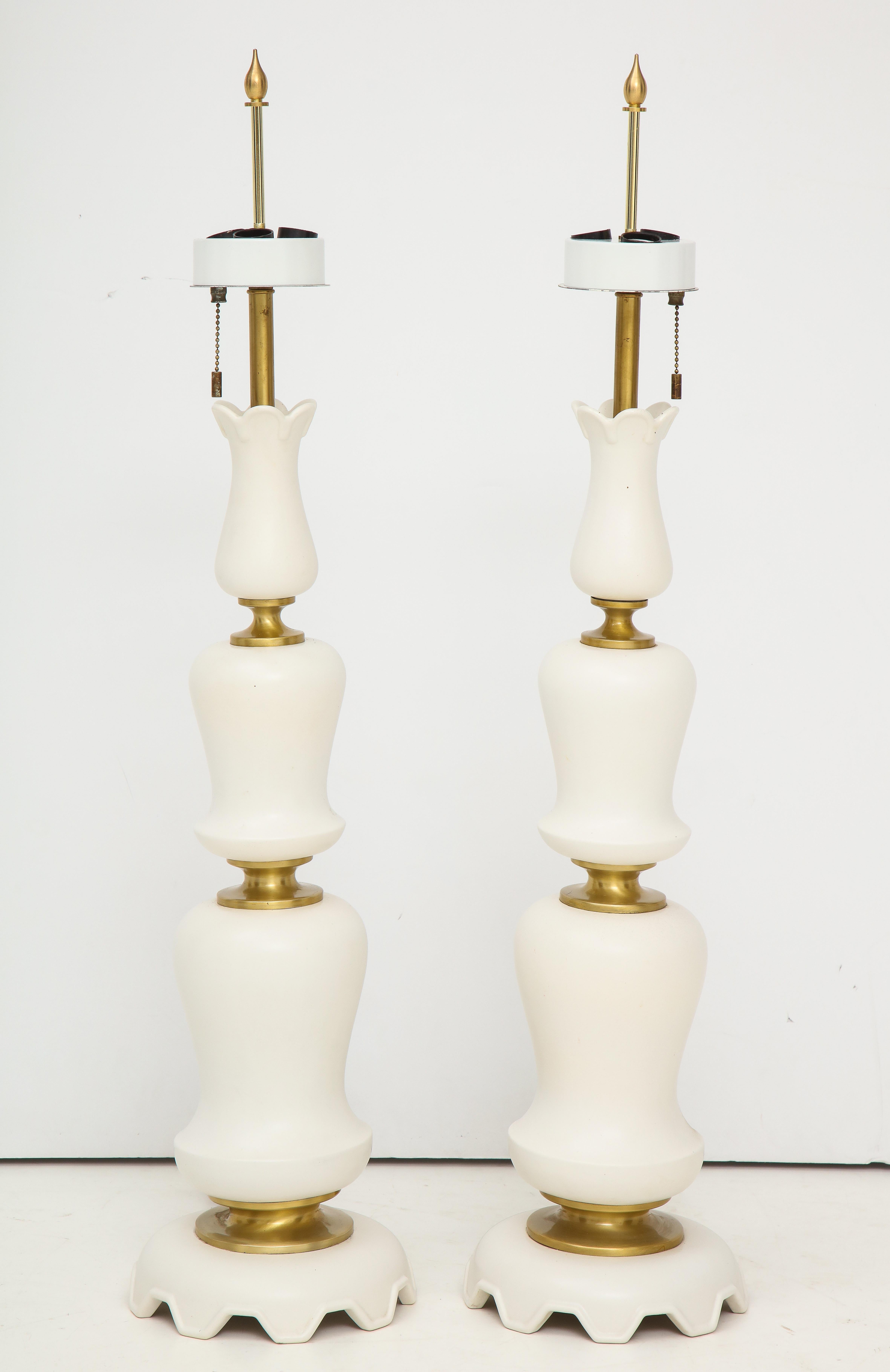 Pair of sculptural table lamps in a white Matte porcelain by Gerald Thurston for Lightolier.
The lamps each have three light sockets and they have been newly rewired.
One lamps has a slight hairline crack towards the bottom, as seen in the last
