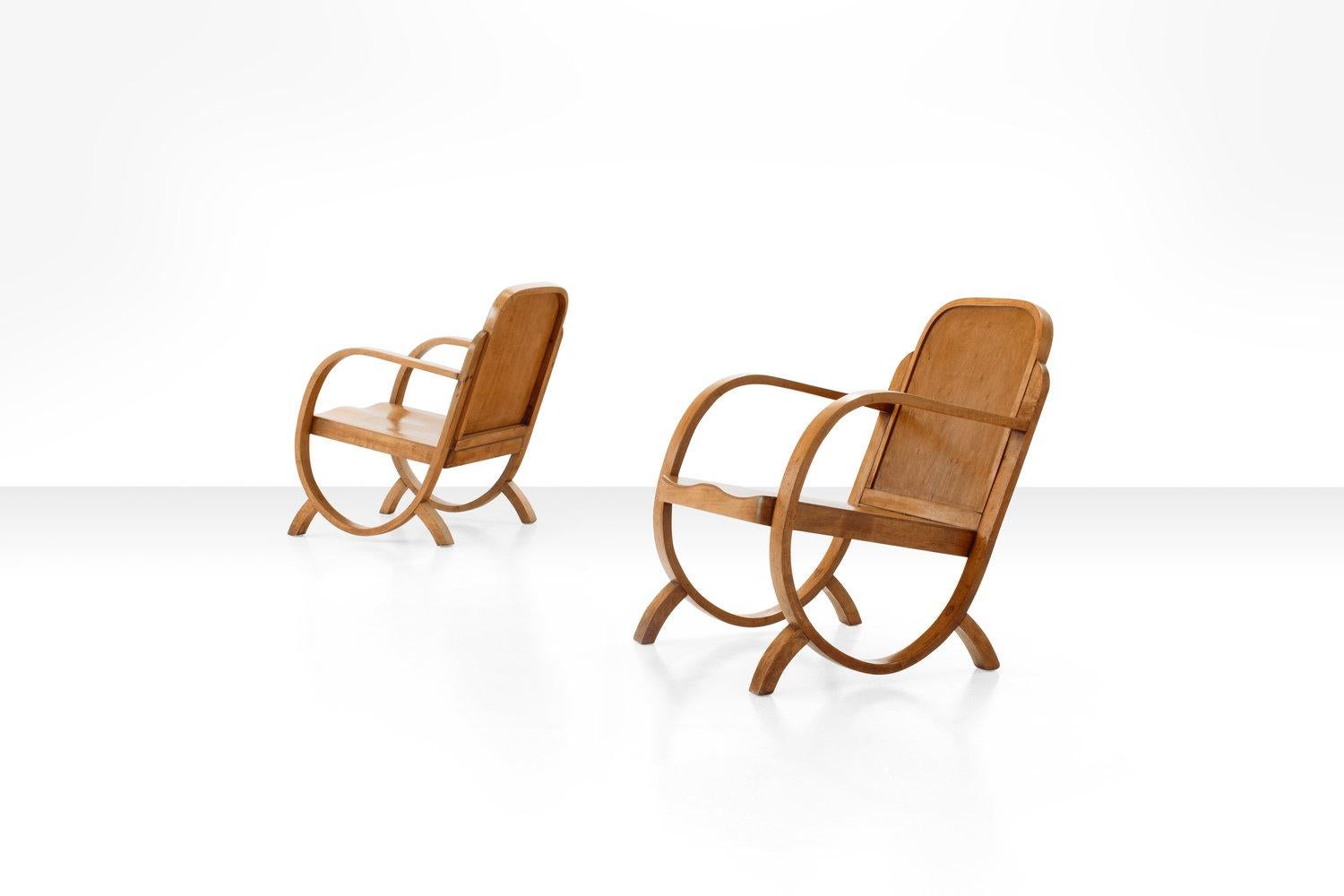 Pair of Gerdau armchairs in caviuna wood from Brazil, 1930s.

This pair of armchairs is playful and modest, but with strong geometric lines in Art Deco style. The bentwood armrest go full circle, down to the legs and up to support the backrest,