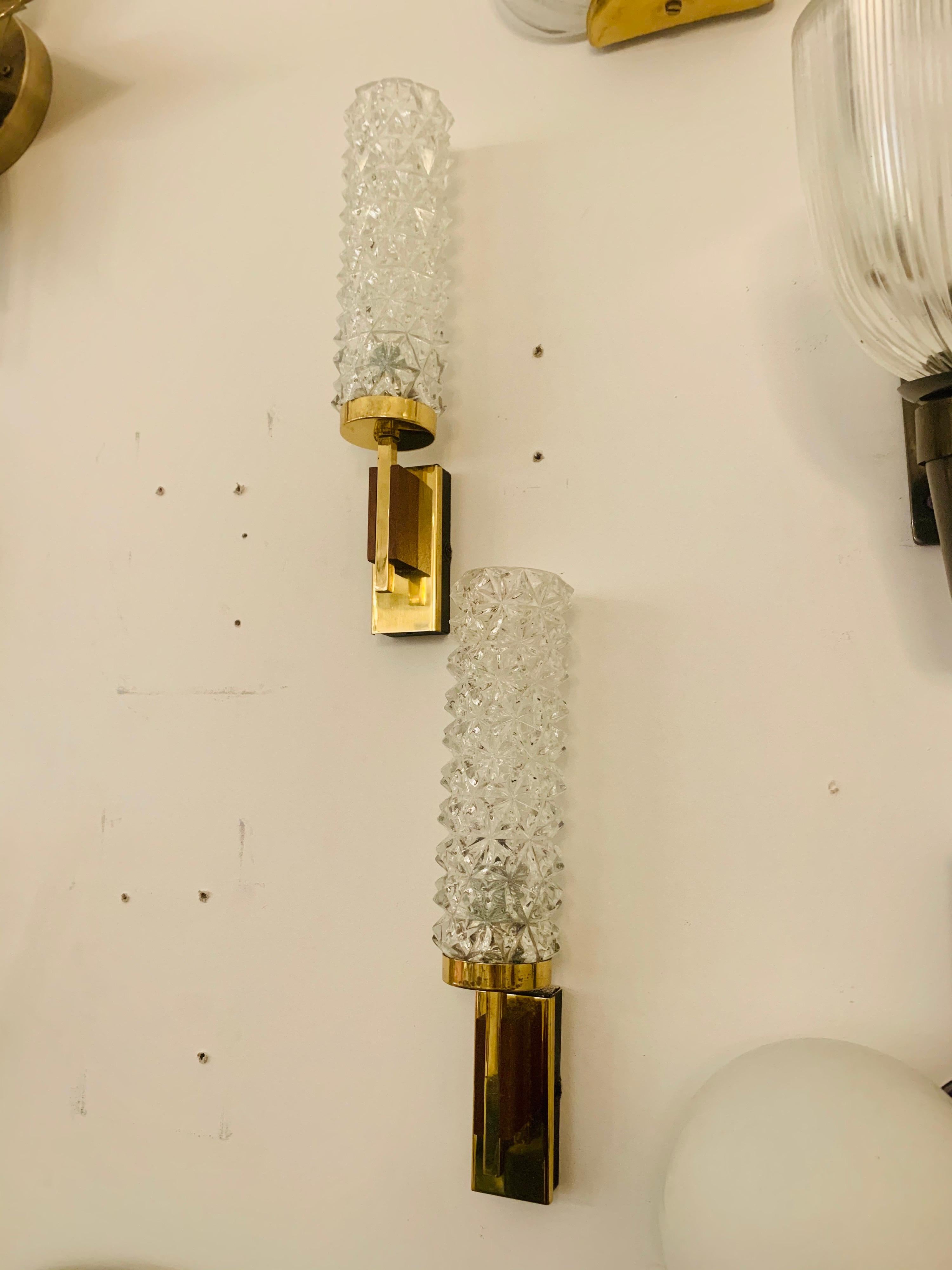 A pair of German 1960s polished brass and walnut sconces with cut crystal shades.