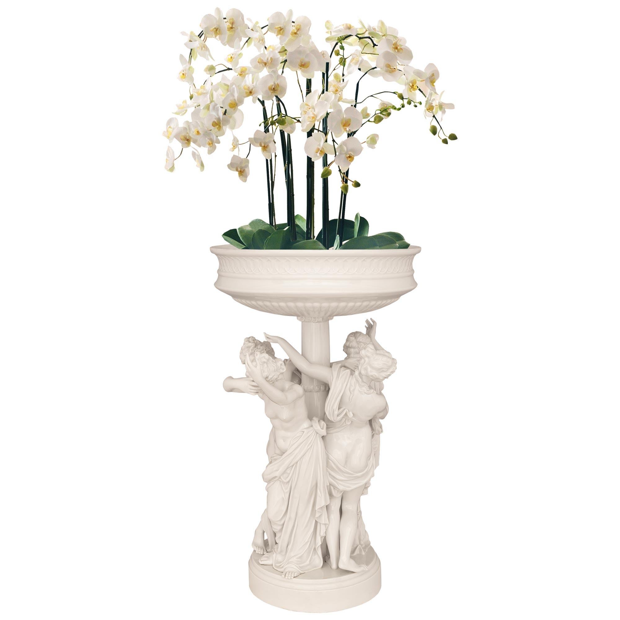 A stunning and exquisitely detailed pair of German 19th century Louis XVI st. Dresden porcelain planters, signed Dresden. Each circular planter is raised by a mottled edge pedestal and supported by a central fut column with a scrolled capital and