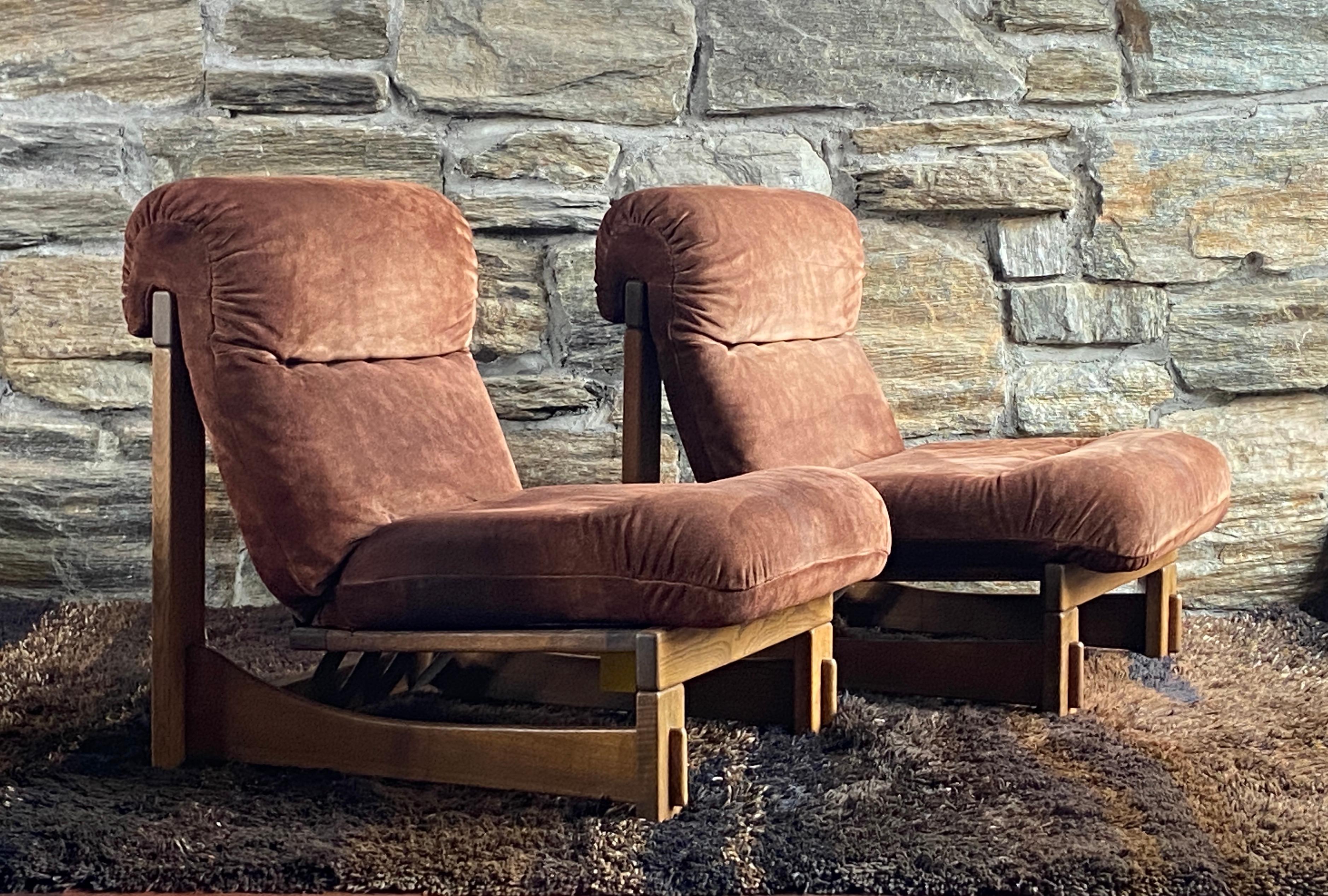 Amazing pair of  oversized Scandinavian styled German brutalist lounge chairs. The heavy oak frames have beautifully crafted  through mortis and tenon joinery, cushions are upholstered in a brown suede leather supported by sling straps, upholstery