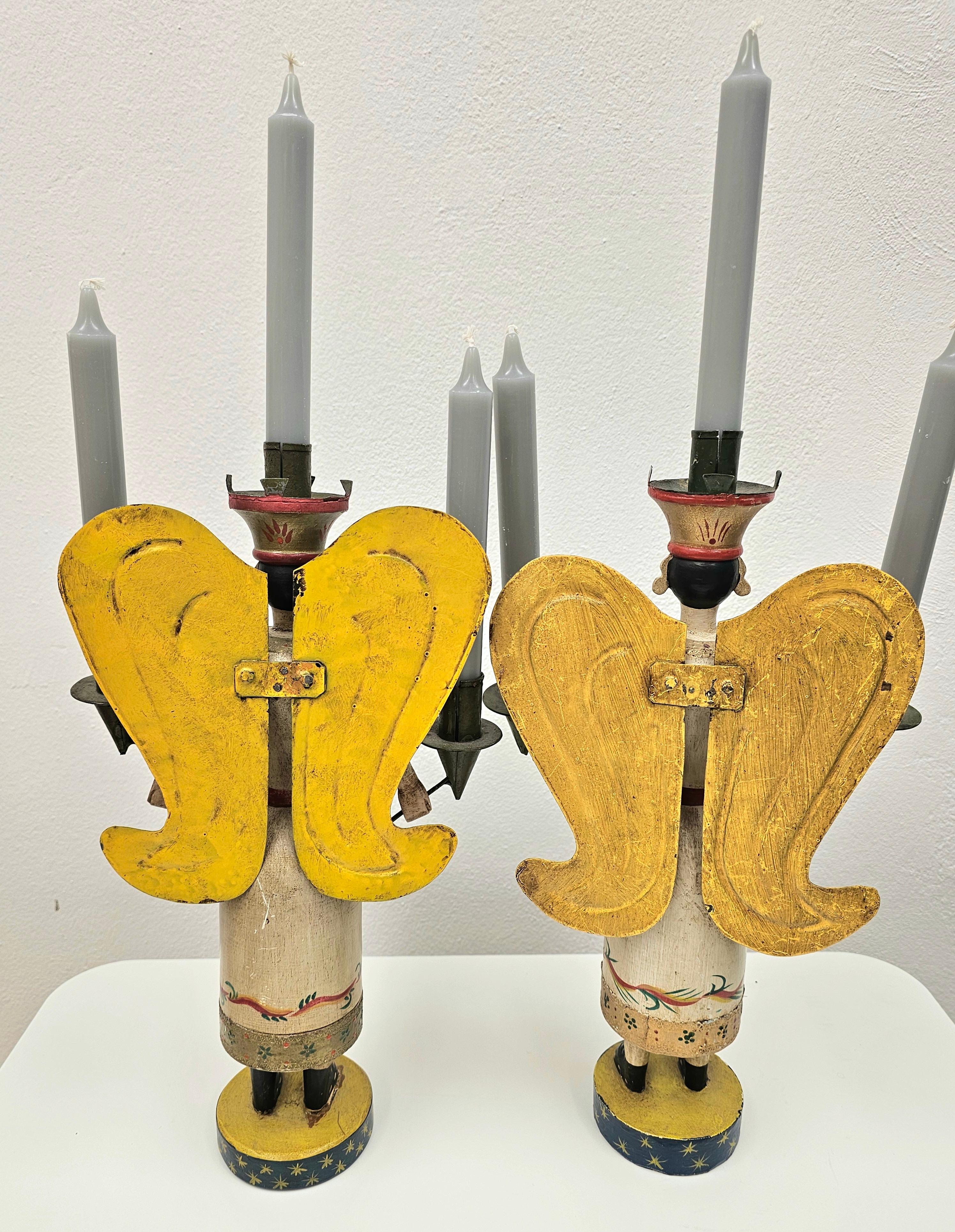 Pair of Mid-20th Century large German Christmas angel sculptures hand-crafted in wood. From the Erzgebirge/Germany. The traditional hand carved angels are hand painted and stand on a round hand-painted wooden plateau.
The angel is carfted in wood