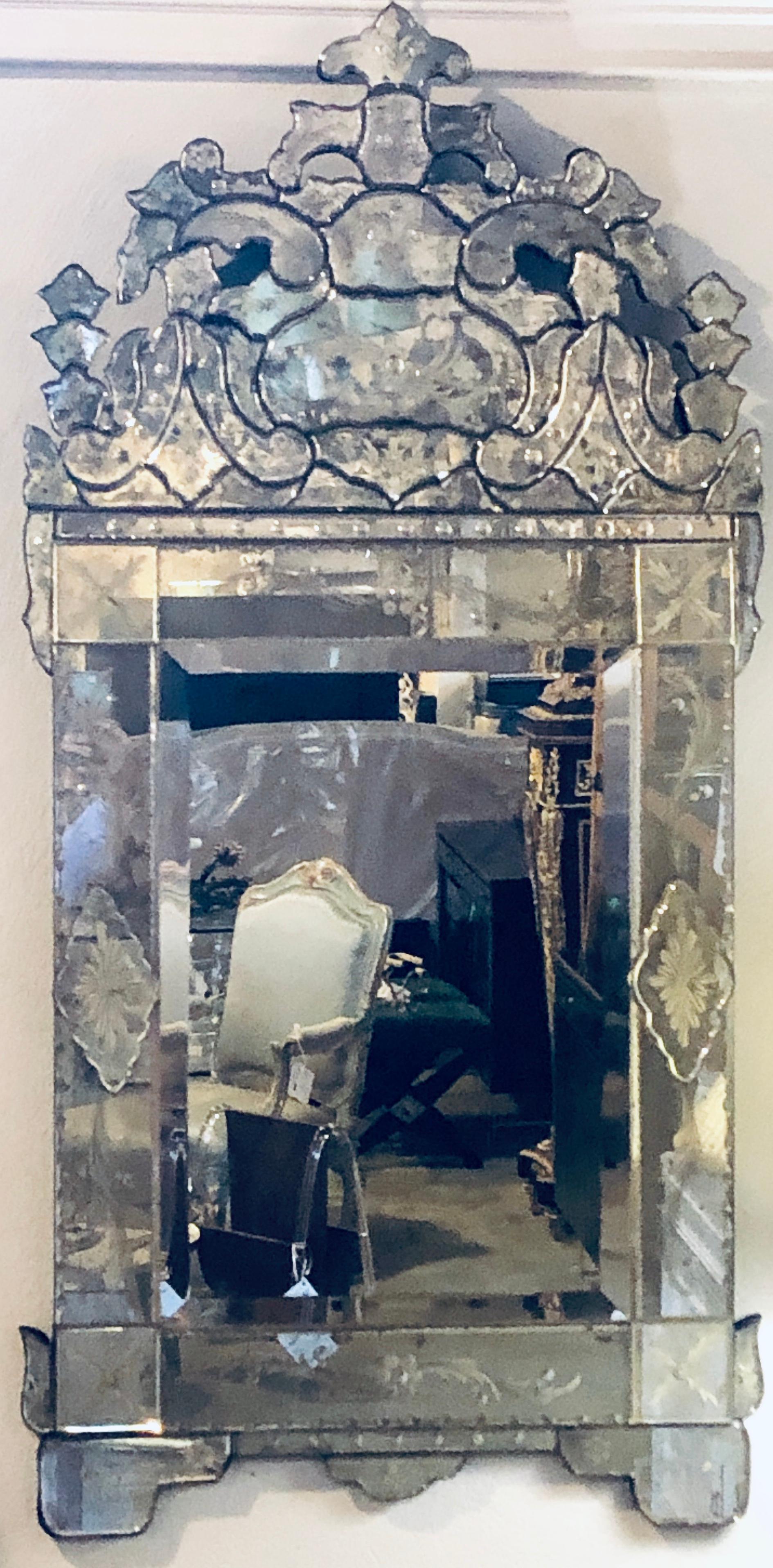 Pair of lovely Venetian style wall mirrors with beautiful etching in glass. The center panel is a clear mirror framed in a fine group of many etched glass parts with a pierced glass carved pediment top.