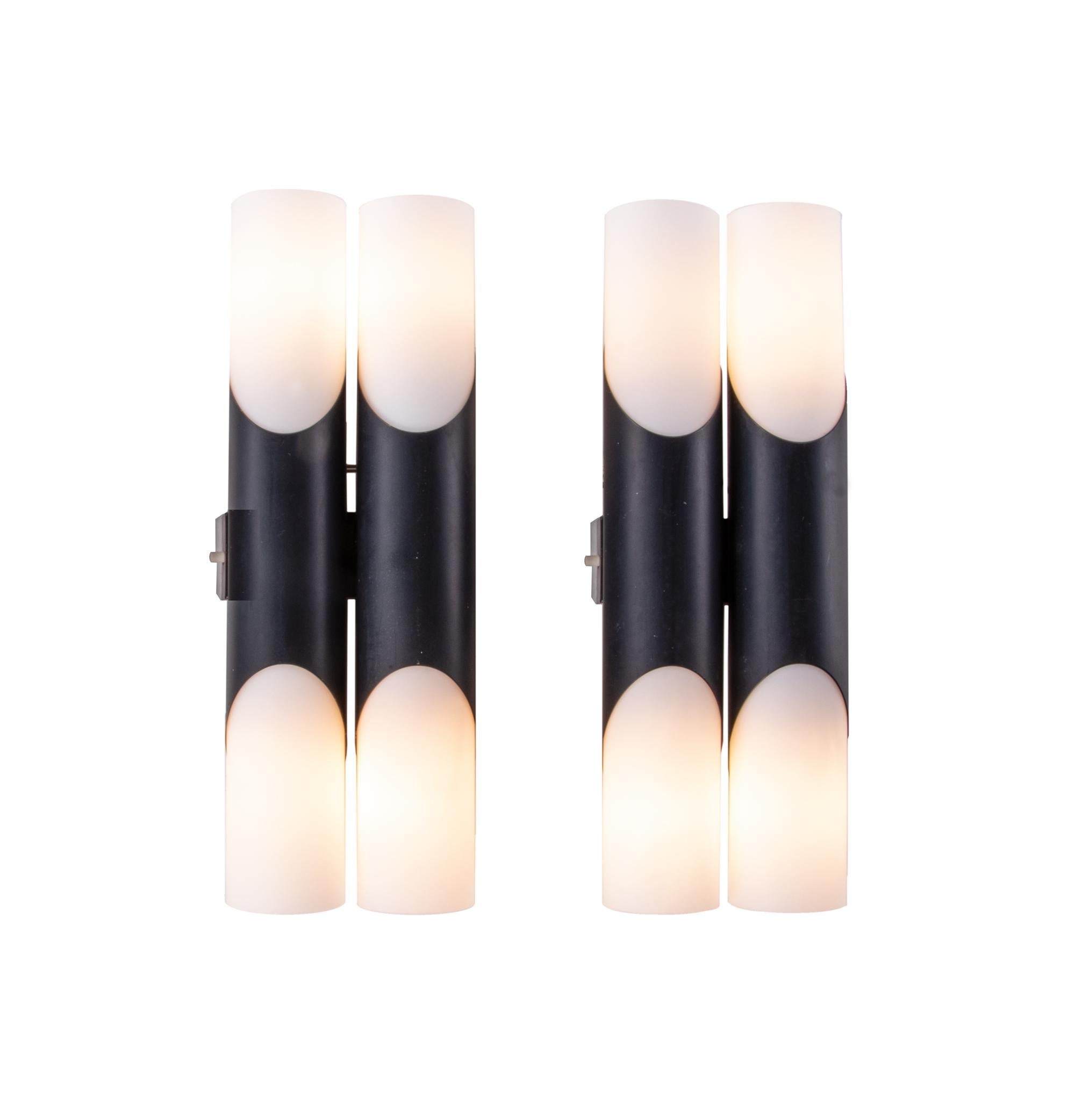 Elegant pair of modernist double wall sconces with white opal glass diffusers on a tubular black brass frame. Designed by Rolf Kruger. Manufactured by Neuhaus Lighting, Germany in the 1970s. 

Design: Rolf Kruger. 
Style: mid-century, modernist.