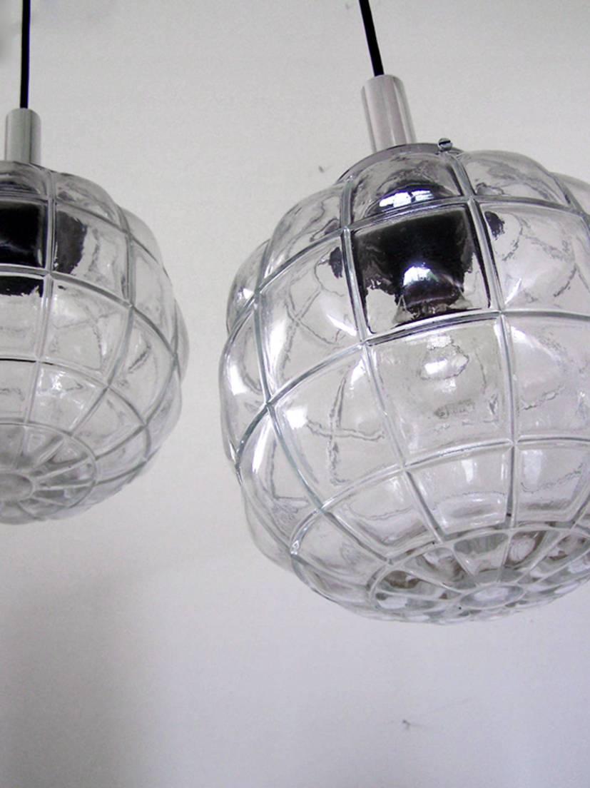 Pair of clear glass and chrome pendants by Limburg,
Germany, 1960s.
These sculptural pendants would look wonderful hanging over the eating area or over the kitchen island.
Lamp sockets: One E27 (US E26).
 