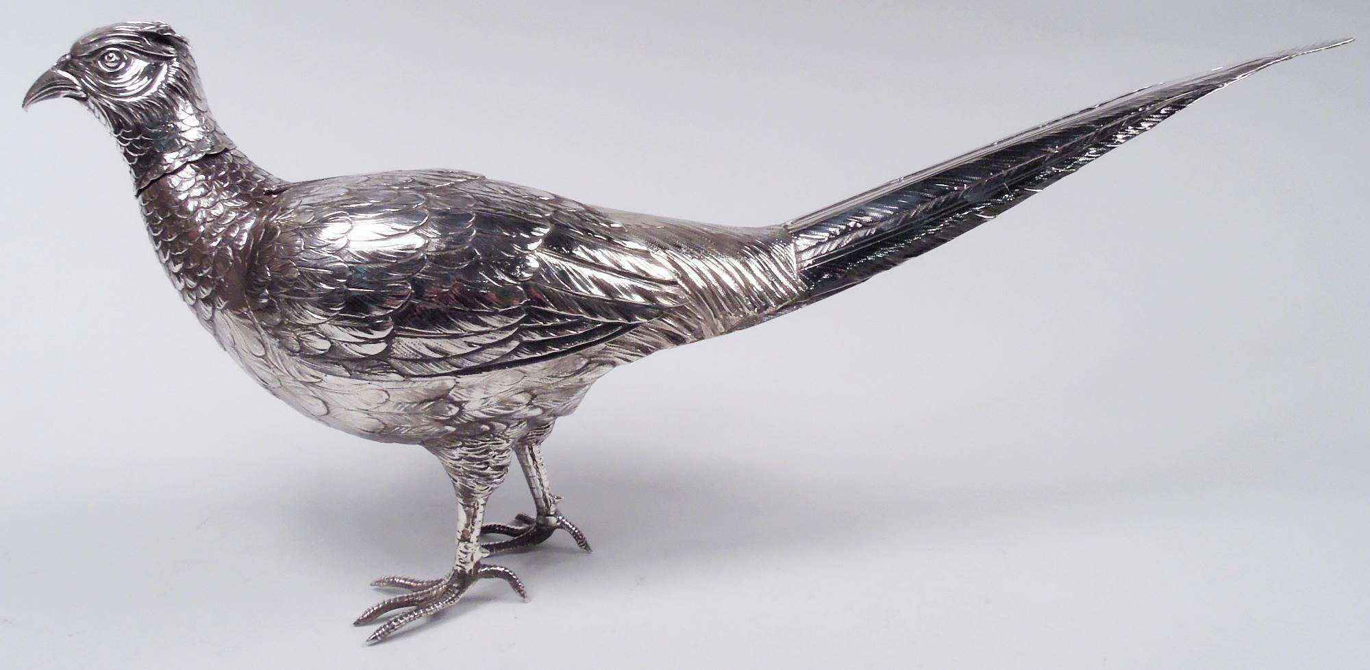 Pair of German 800 silver pheasants, ca 1920. A rooster and hen, each with hinged wings, long overlapping tails, closed beak, and wary stare. An on-guard couple standing on scaly talons, ready to take flight if the party talk turns dull. Heads