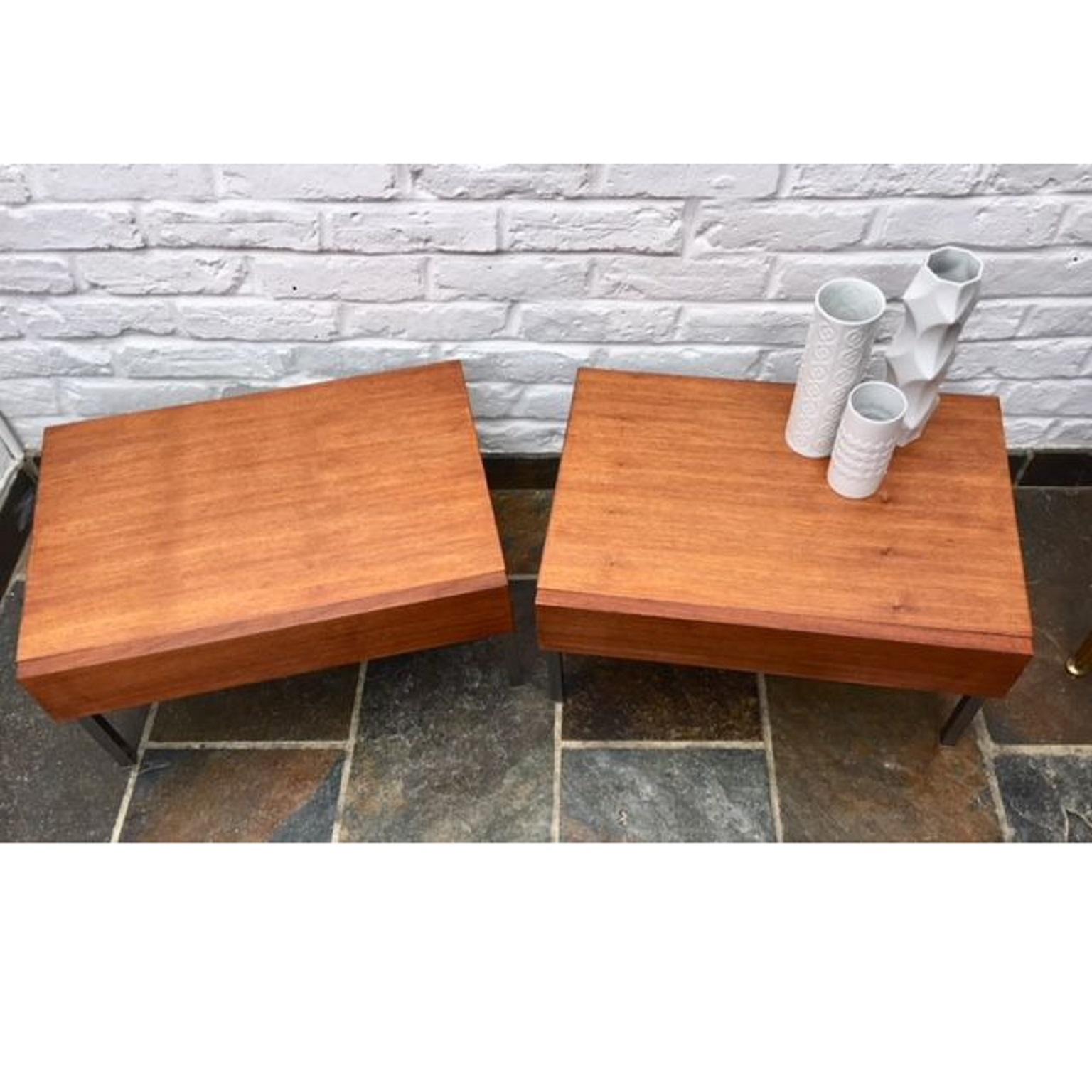 Pair of German ‘Interlübke’ bedside tables / nightstands, 1970s.

A lovely pair of German teak bedside tables by Interlübke. One large ‘invisible’ handle-less drawer, on stripped steel legs, with floor protecting feet caps.
These are a really