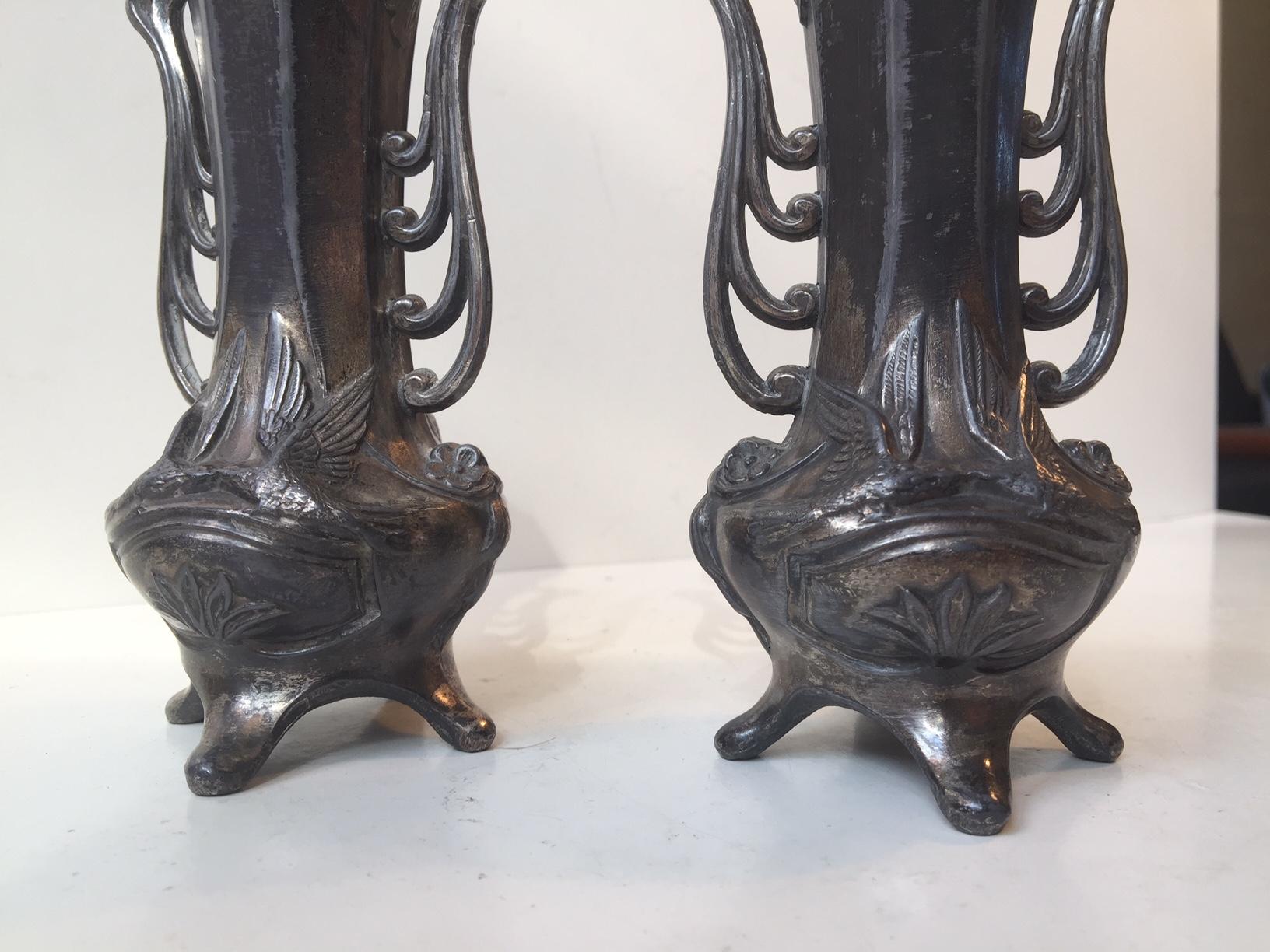 A matching pair of pewter vases with streamlined ornamentation. Charming ware and patina. Both imprinted Germany to the base.
