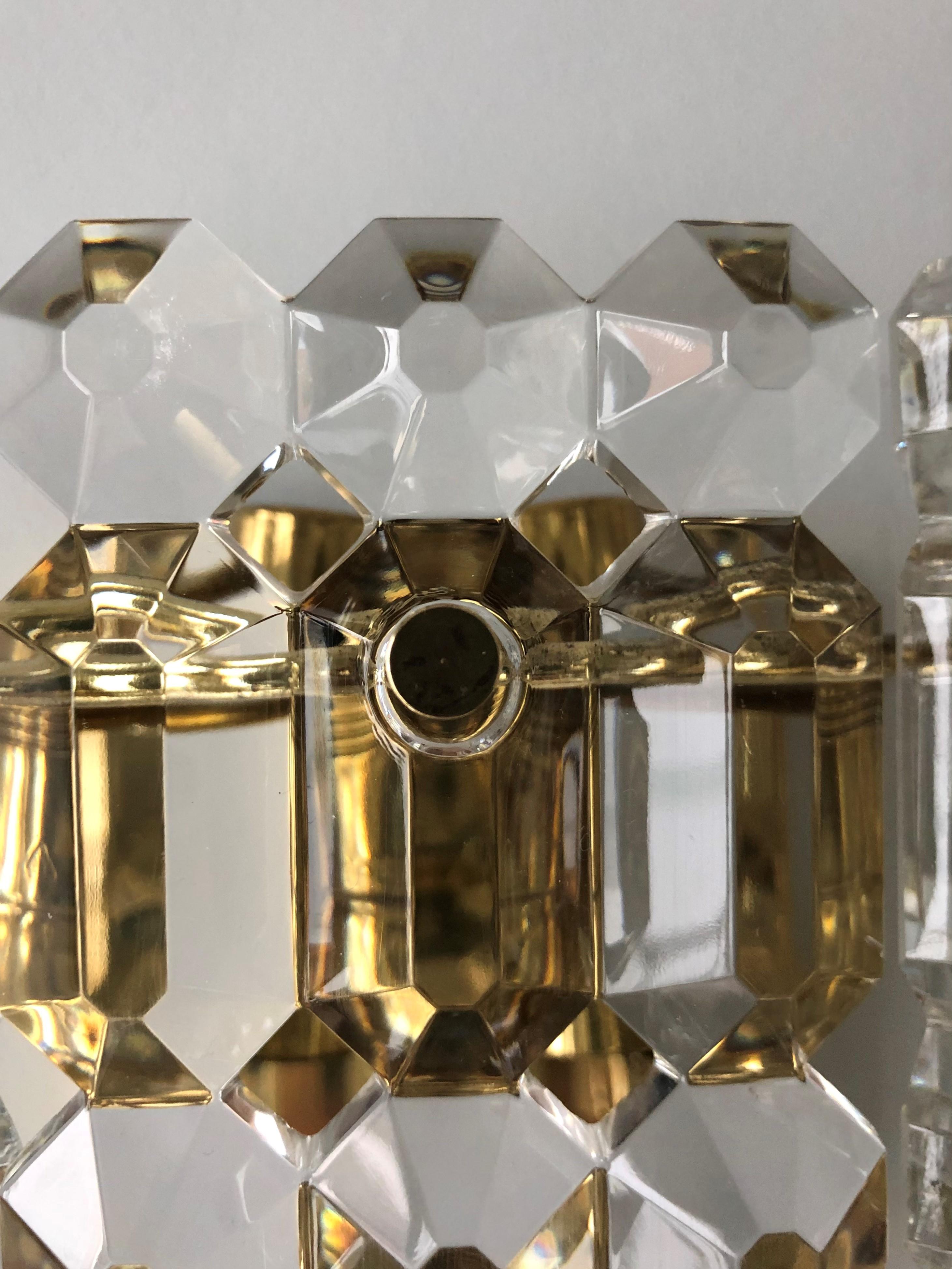 Beautiful and lovely German Mid-century crystal Wall Sconces. These Wall Sconces were manufactured during the 1970s in Germany by Kinkeldey-Leuchten. Each fixture is composed by 3 crystals and brass structure. A professional electrician has checked