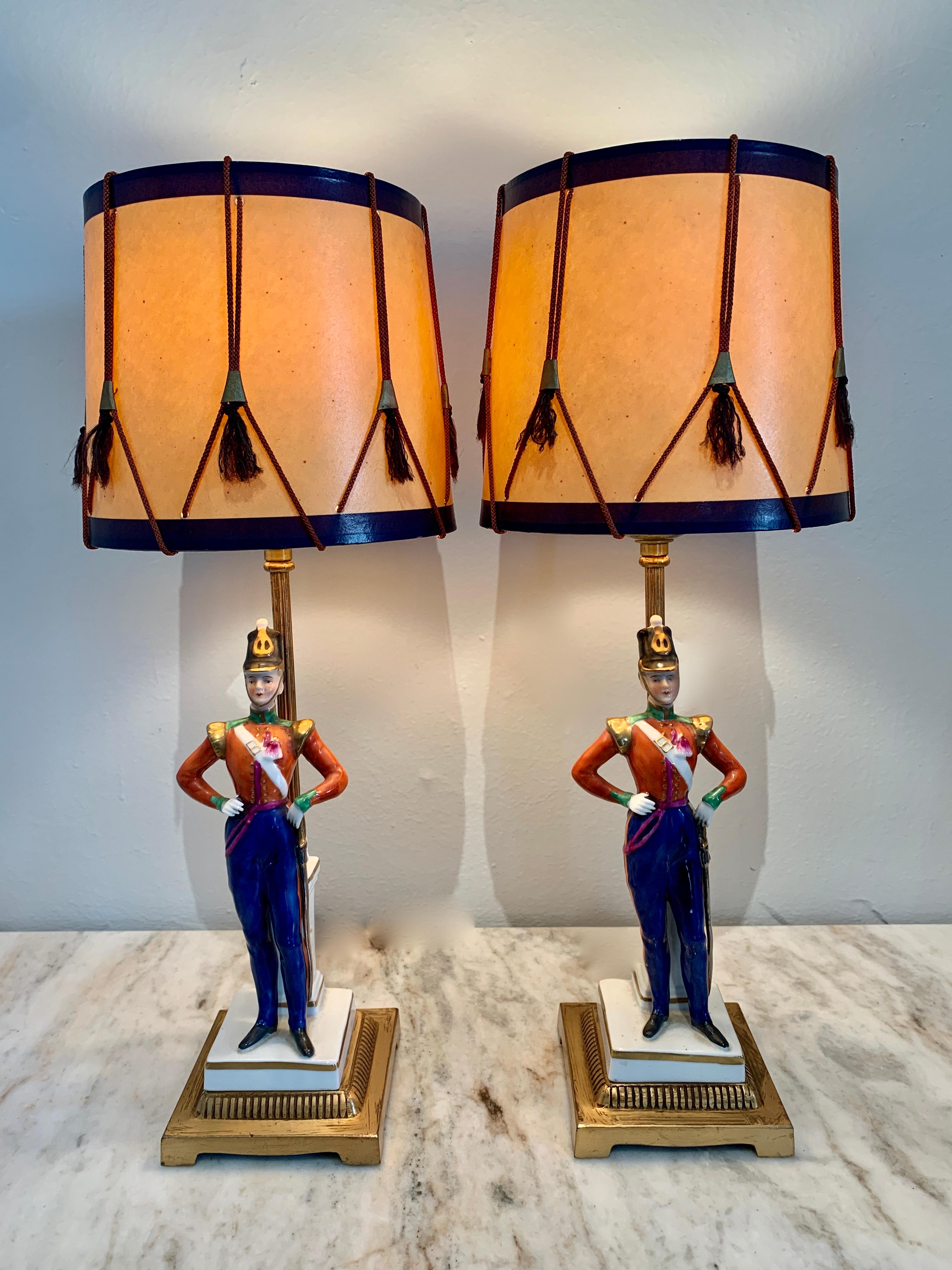 Pair of German Porcelain soldier lamps on bronze mounts with drum shades

An unique and rare pair of adorable soldiers well suited for any prestigious office or most definitely the Childs room. The porcelain is in very good condition with no