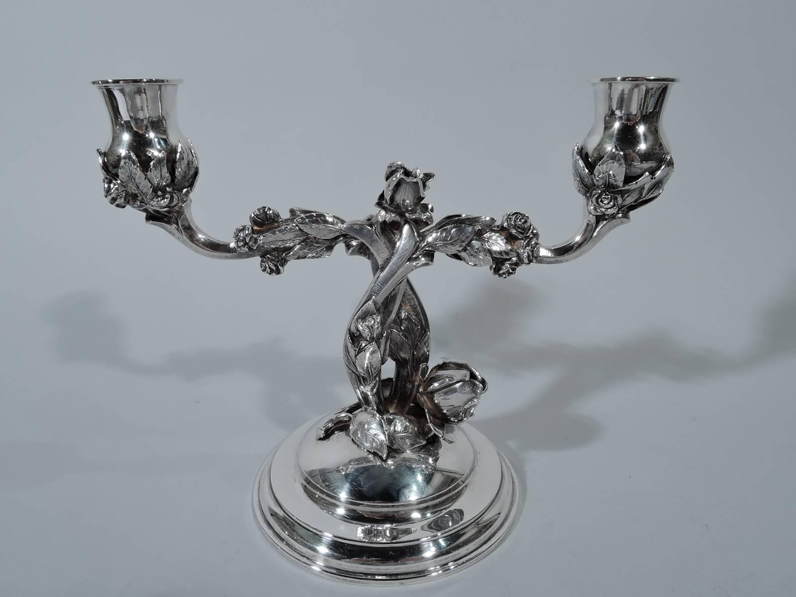 Pair of German sterling silver two-light candelabra. Stepped and domed base to which are mounted two entwined rose branches, each terminating in plain single socket. Tactile and irregular leaves and blossoms. Marks include Ott-Heydendahl Wiesbaden