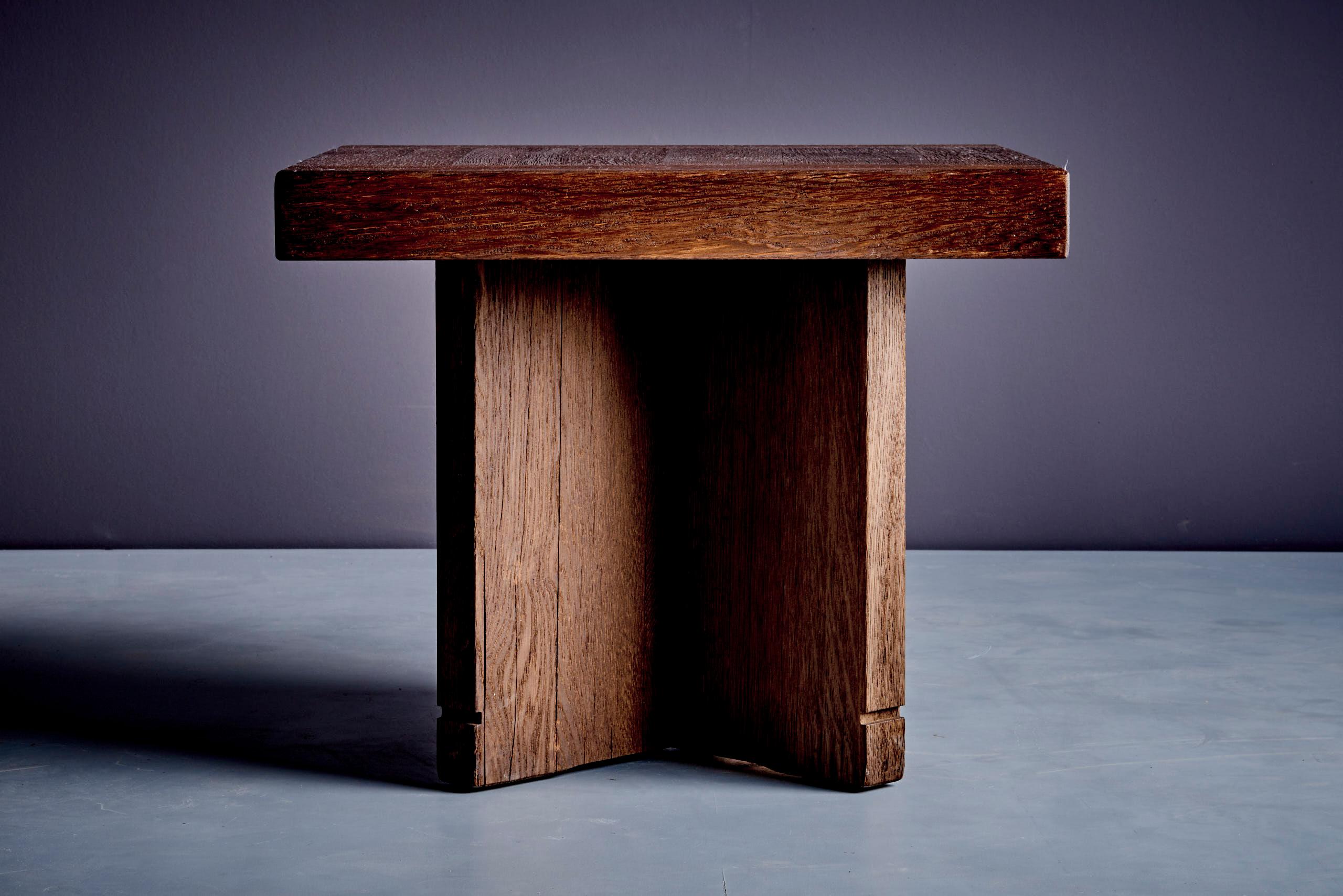 Elegant and robust pair of side tables in solid oak, crafted in Germany in the 1960s. Featuring a square top with visible dovetail joinery and a sculptural cross-base, these pieces offer timeless design and craftsmanship. Perfect as end tables or