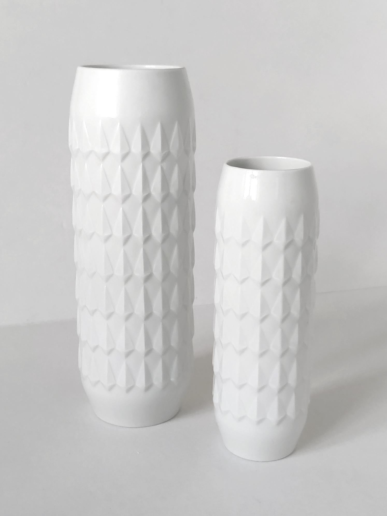 Beautiful sculptural pair of white porcelain vases by Hutschenreuther.
Germany, 1960s.
Measures: 
1. Height 10.8 In
2. Height 8.5 In.
  