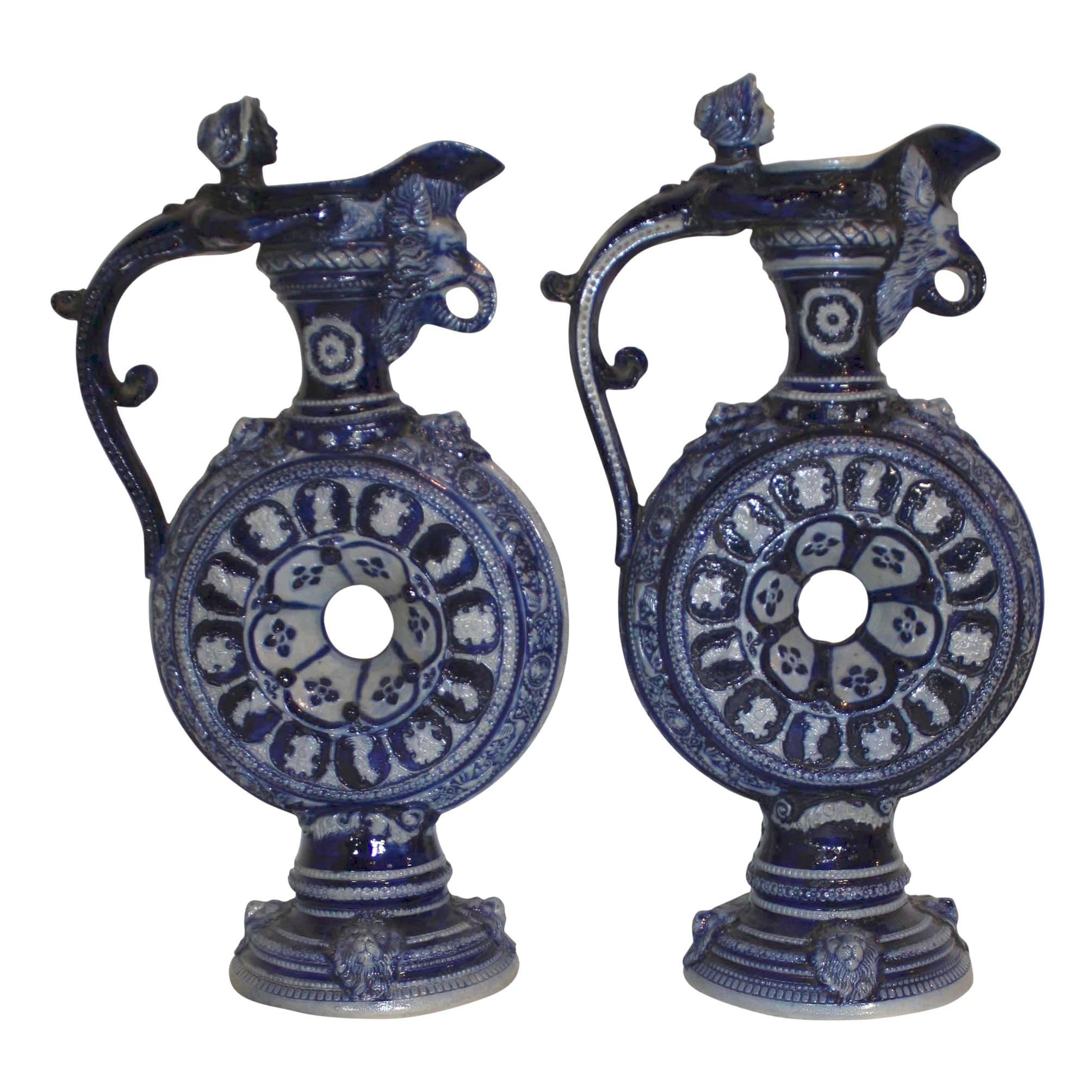 The characters on this set of ewers are diverse and intriguing. From the mermaid handles, wild boar spouts, and faces of royalty around the circular belly to the lions at the base, each detail is impressive. While the design of each ewer is the