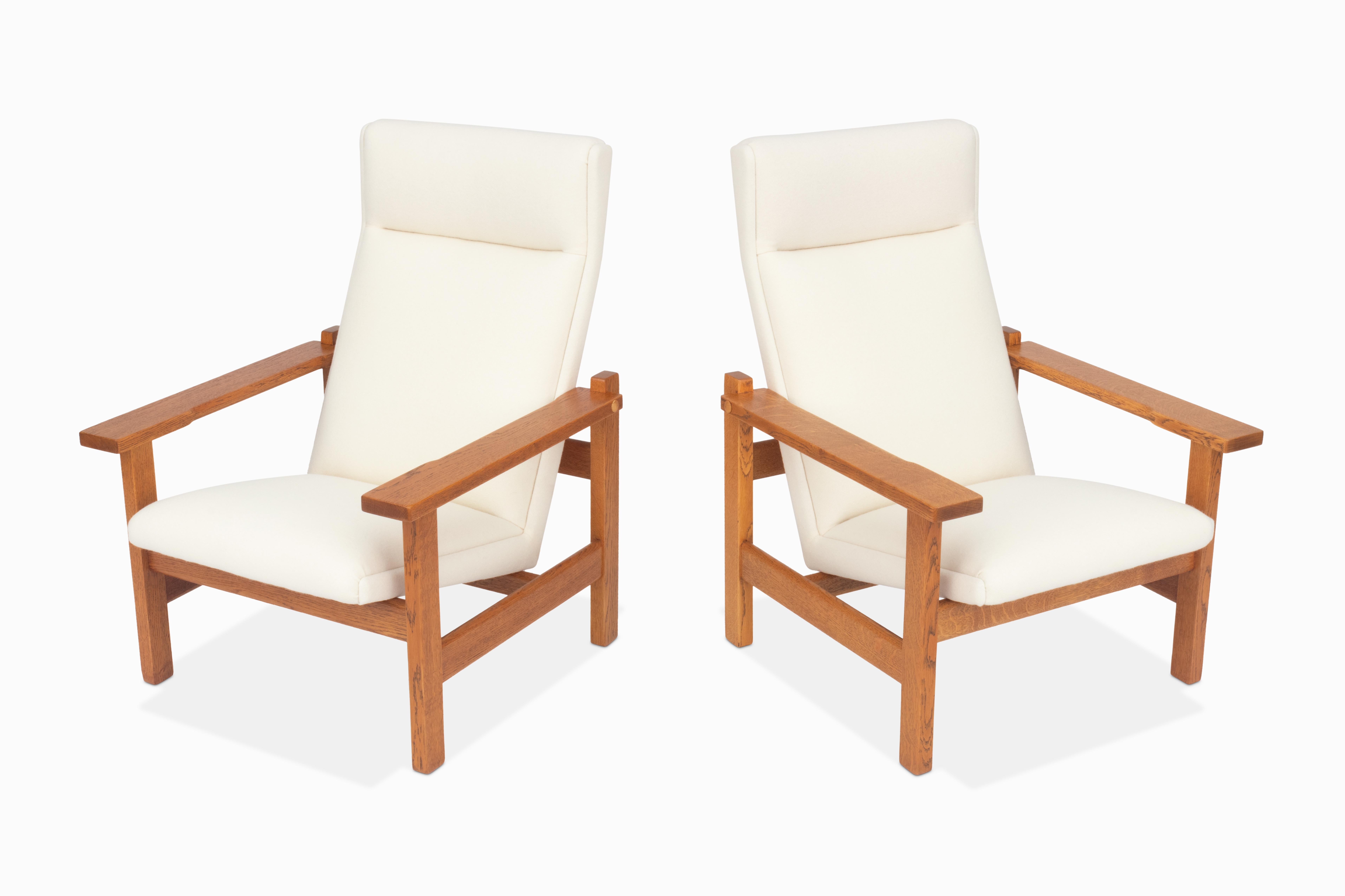 Here is a pair of large highback lounge chairs by Hans Wegner. These chairs are equally as beautiful as they are rare! Very uncommon in the United States. They feature gorgeous quarter sawn oak frames and new Kvadrat Tonus wool upholstery. Both