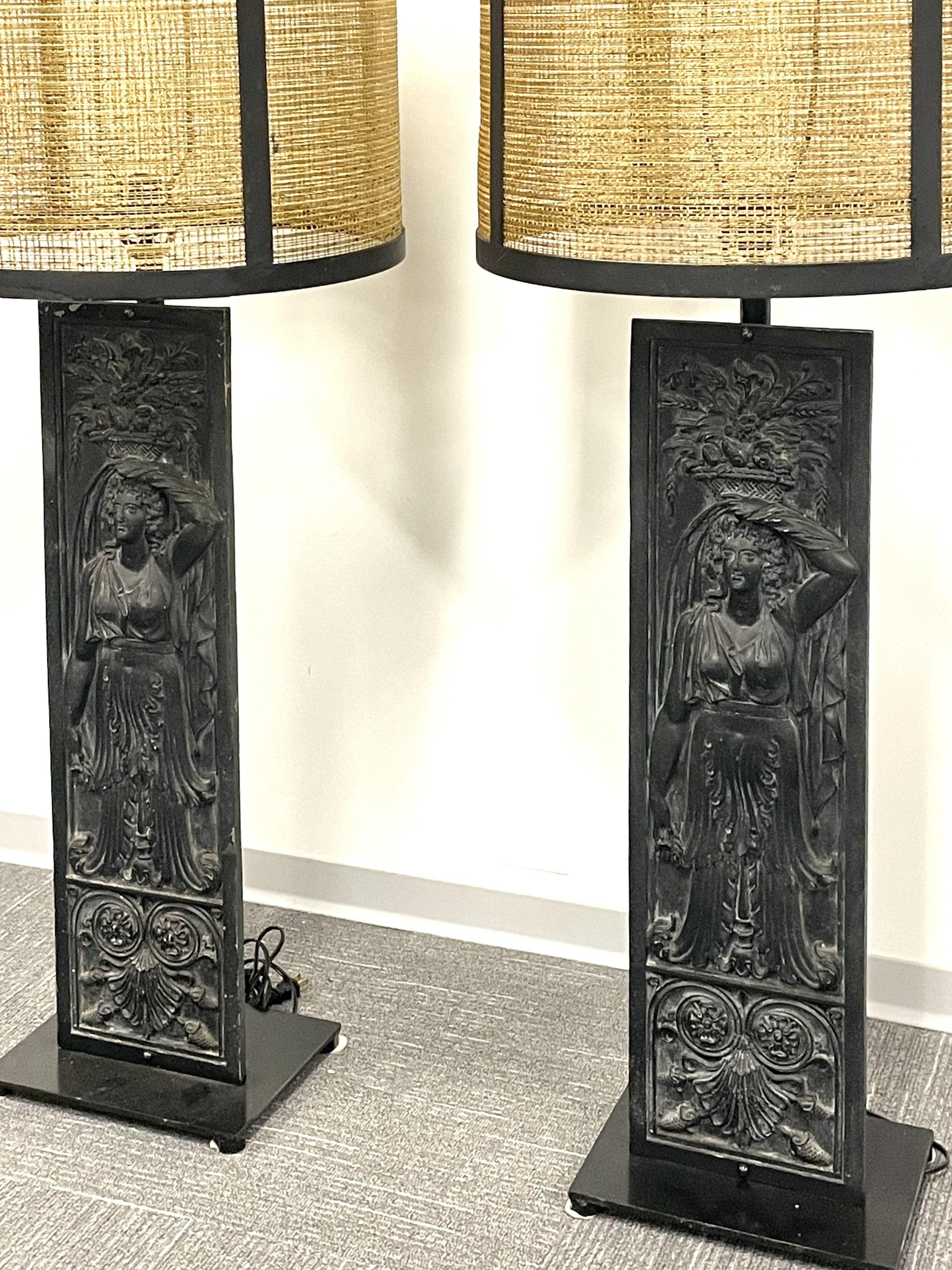 A pair of large and impressive table lamps in the fashion of Diego Giacometti. Each Arts & Crafts inspired center panel depicting a Grecian water bearer in full dress. The pair with custom wicker metal mounted shades.


ZhAA.