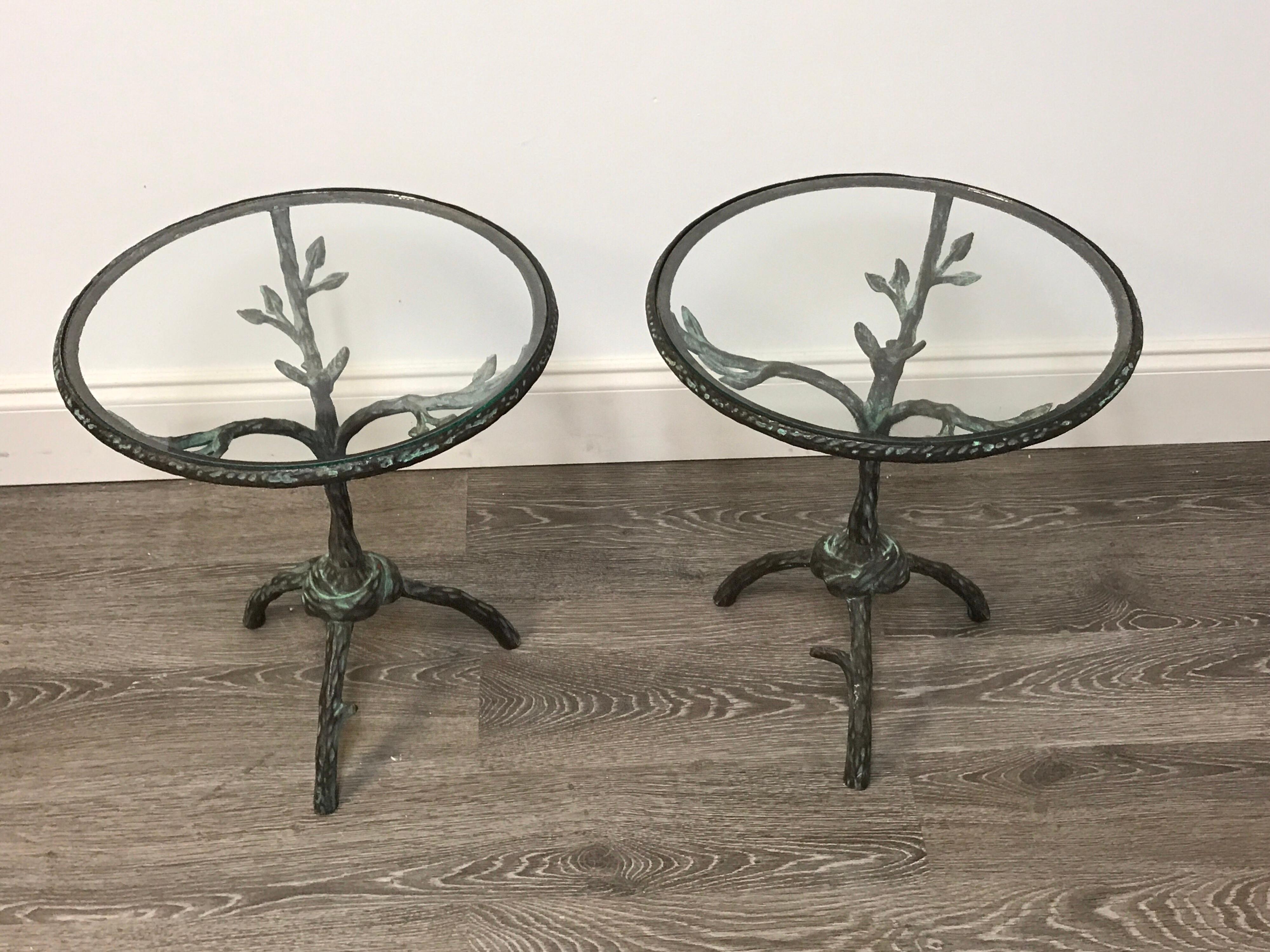 Pair of Giacometti style side tables, each one of circular form with removable inset glass tops, raised on a faux bois base with a central seated bird. The base has an 11