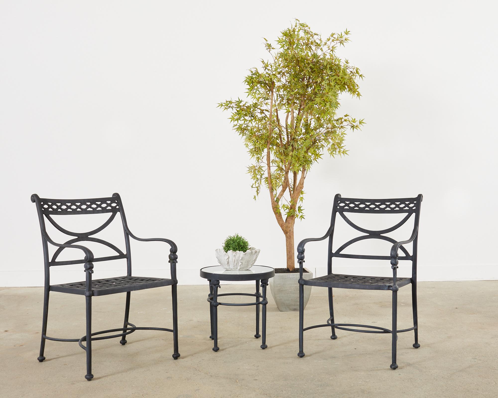 Distinctive pair of round patio and garden drink tables made in the manner and style of Alberto Giacometti. The tables features a hand-crafted wrought aluminum construction with an intentionally aged, ebonized dark finish. The top are inset with a
