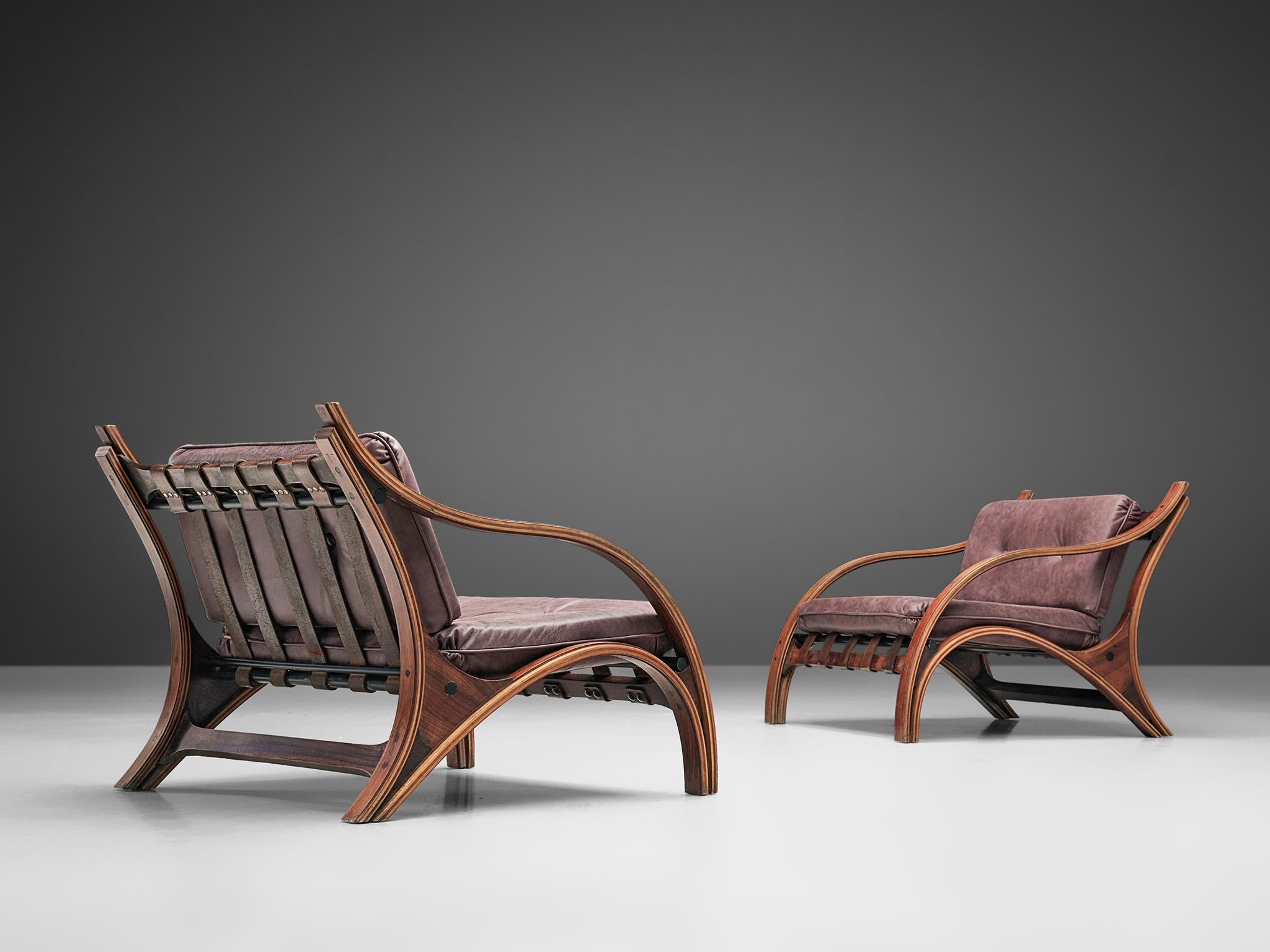 Giampiero Vitelli, pair of lounge chairs to be reupholstered, rosewood and fabric, Italy, 1960s.

Set of Italian armchairs that feature curves and gracious forms. The most interesting feature is the rosewood frame with its fluid lines. Running from