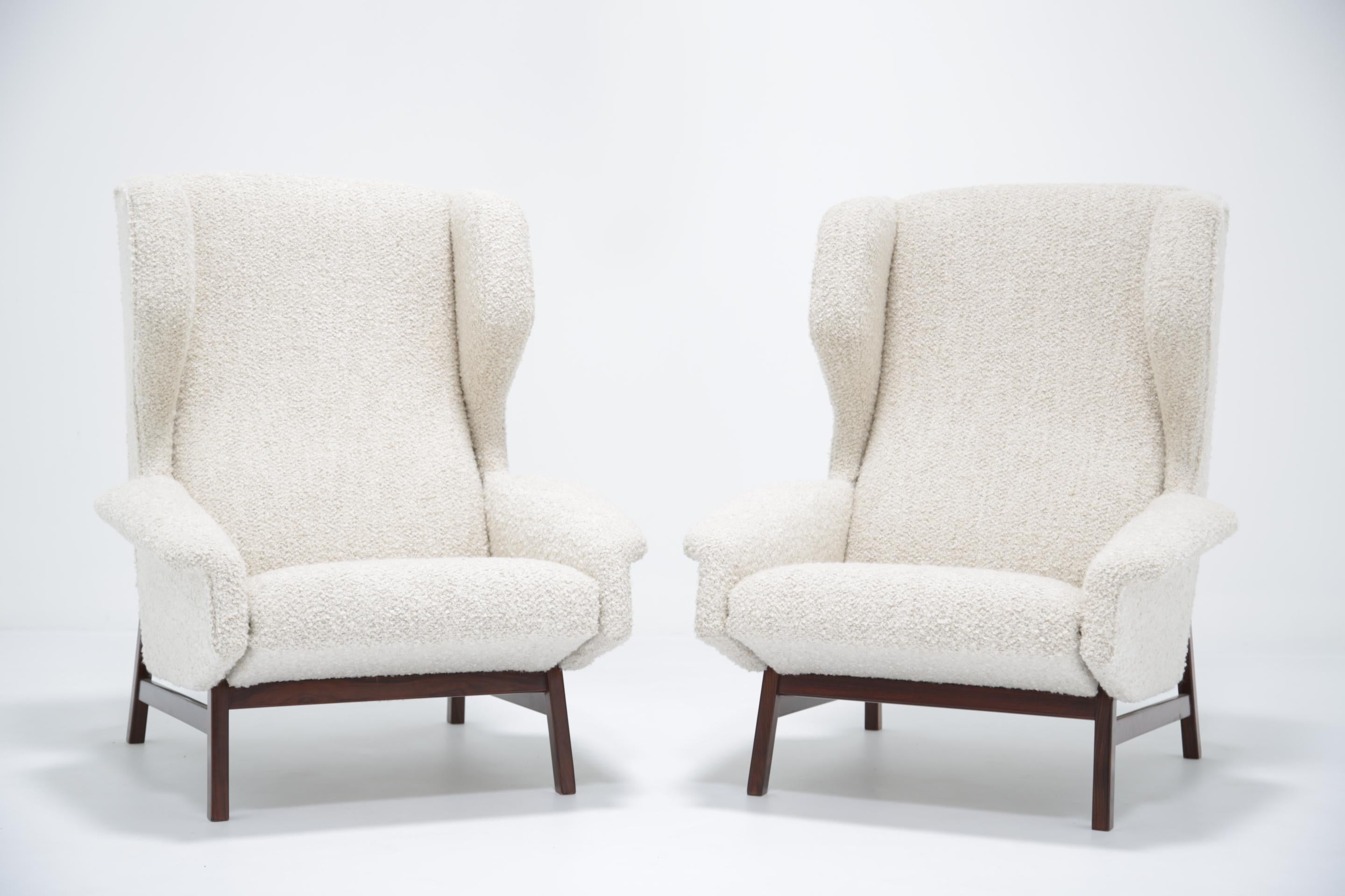 Presented here we have a stunning pair of 1957 Gianfranco Frattini Model 877 Wing Armchairs made by Cassina. The chairs have been fully refurbished and are now presented in a modern Boucle fabric. Winged chairs were designed to give privacy to