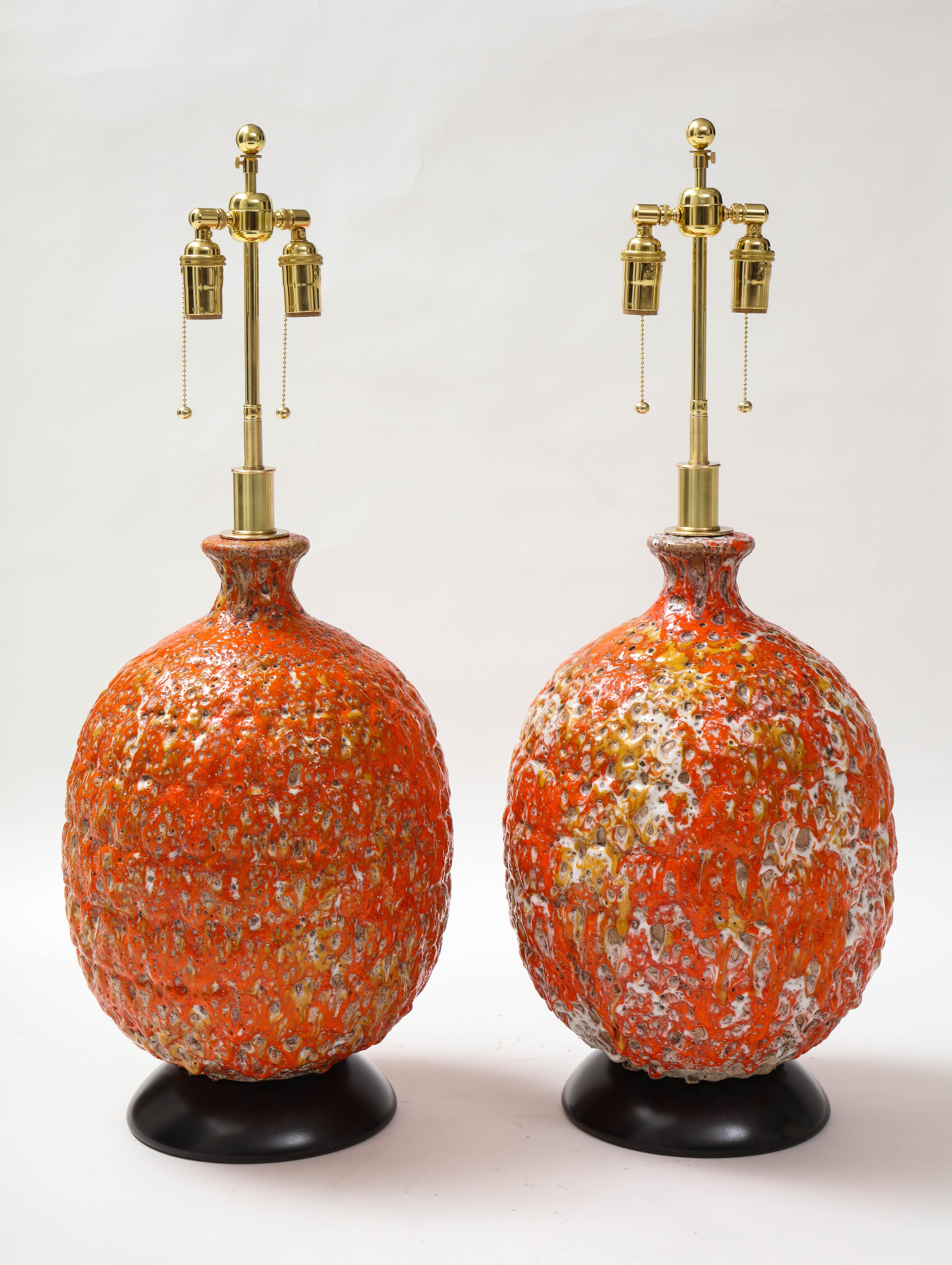 Pair of giant Italian ceramic lamps with a beautiful Volcanic glazed finish.
The lamps have been newly rewired with adjustable polished brass double clusters
that take standard size light bulbs.
The height to the top of the ceramic is 20