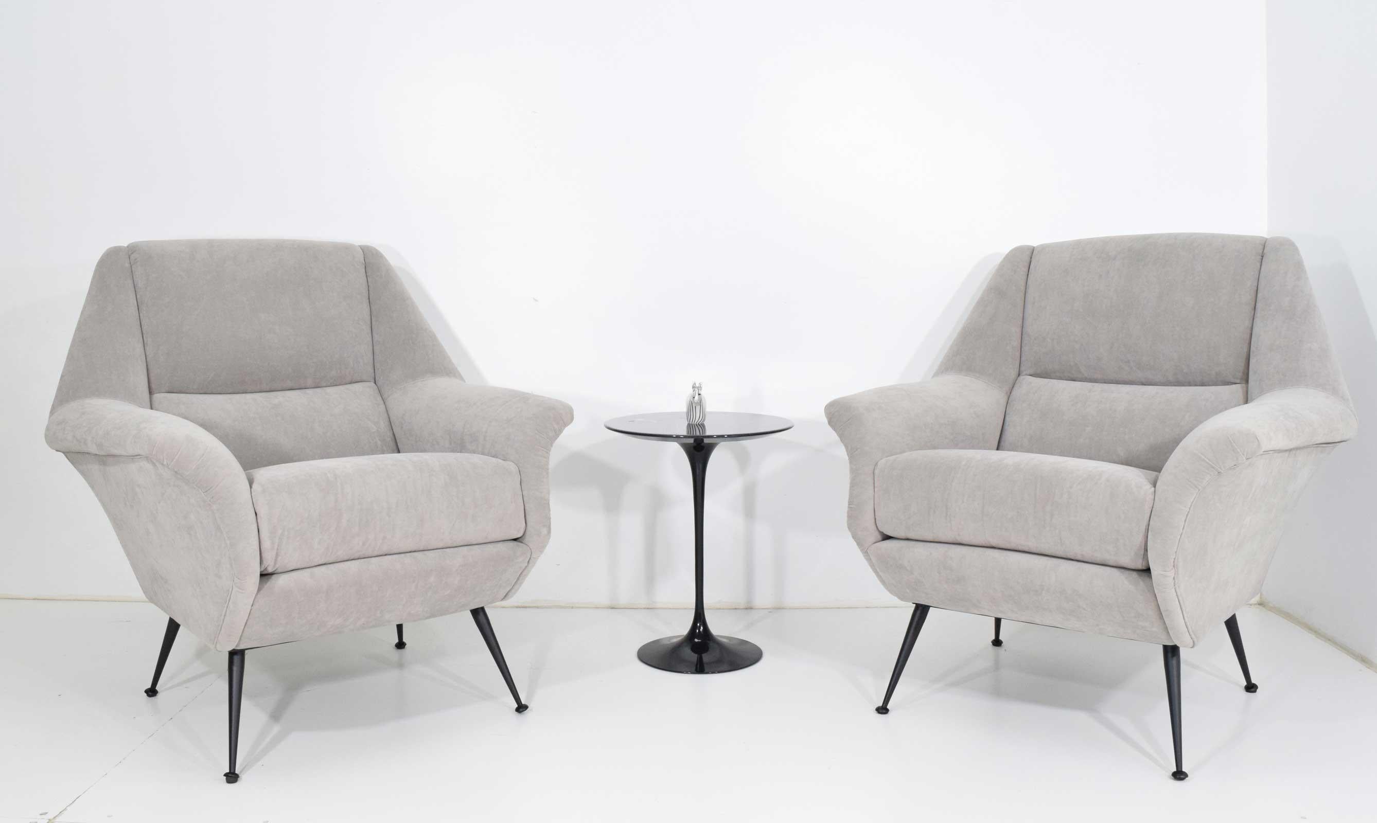 Italian Gigi Radice lounge chairs in a pale gray microfiber. These can be reupholstered to open up the back and eliminate the seat cushion.