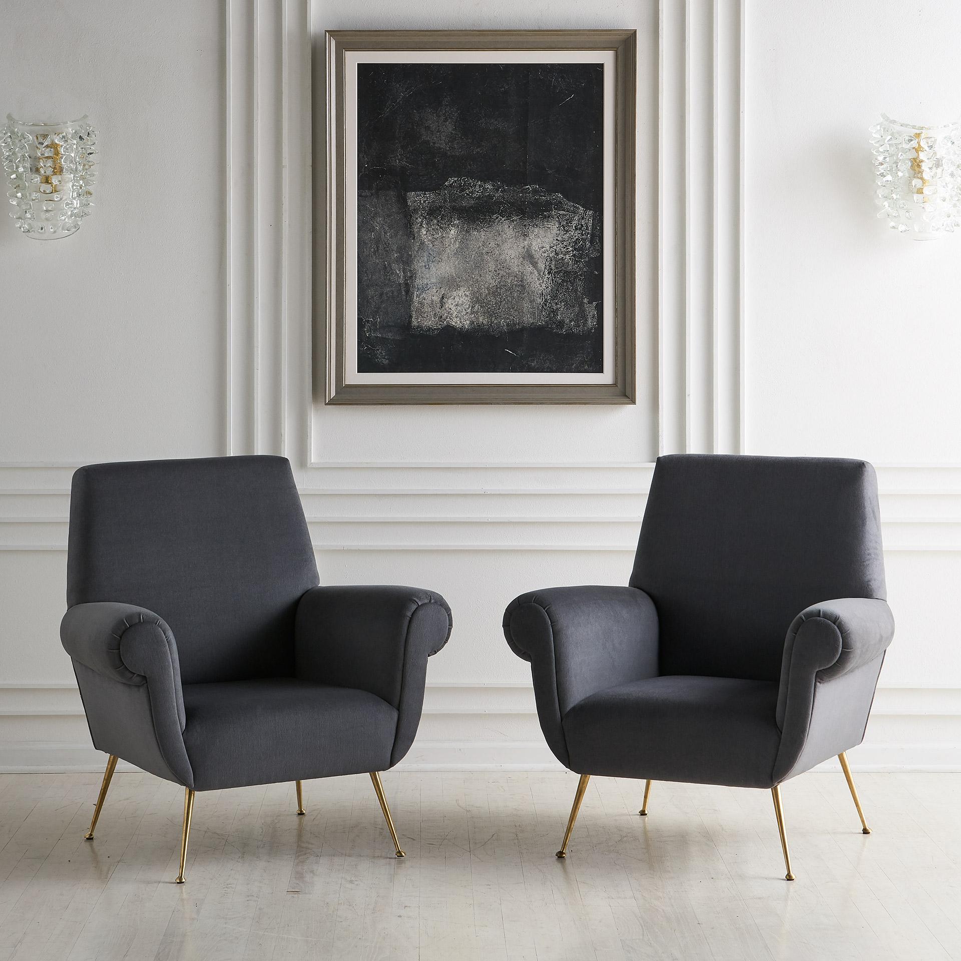 A pair of comfortable and luxurious Italian lounge chairs attributed to Gigi Radice. sourced in Europe. These Italian chairs have been carefully restored and are upholstered in a luxurious gray mohair. Original Brass legs have been polished and