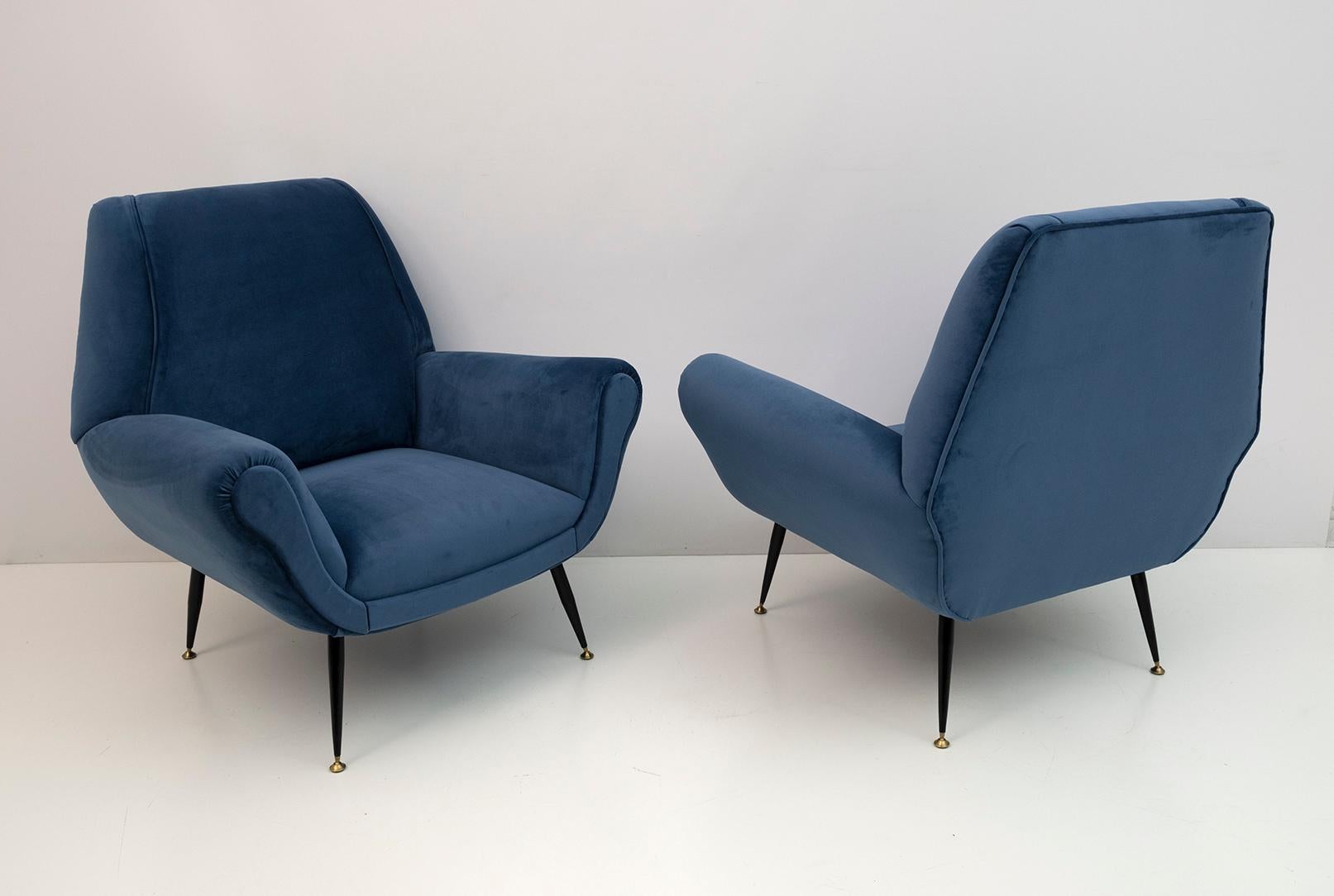 Pair of armchairs designed by Gigi Radice for Minotti. They are made with solid wood structure and blue velvet upholstery with metal and brass legs. The structures are authentic, only the upholstery and padding have been replaced.