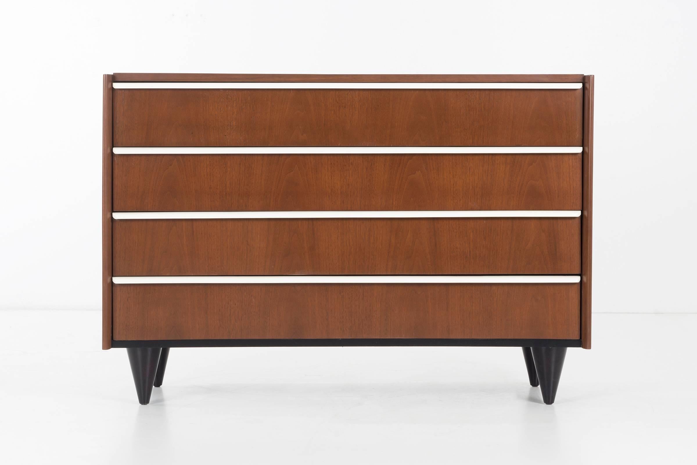 Rohde Classic pair of dressers, four-drawer with long contrasting finger pulls as a element of the design aesthetic.
Bookmatched cathedral veneer in walnut.
Solid turned tapered signature legs.
Professionally restored, all drawers excellent