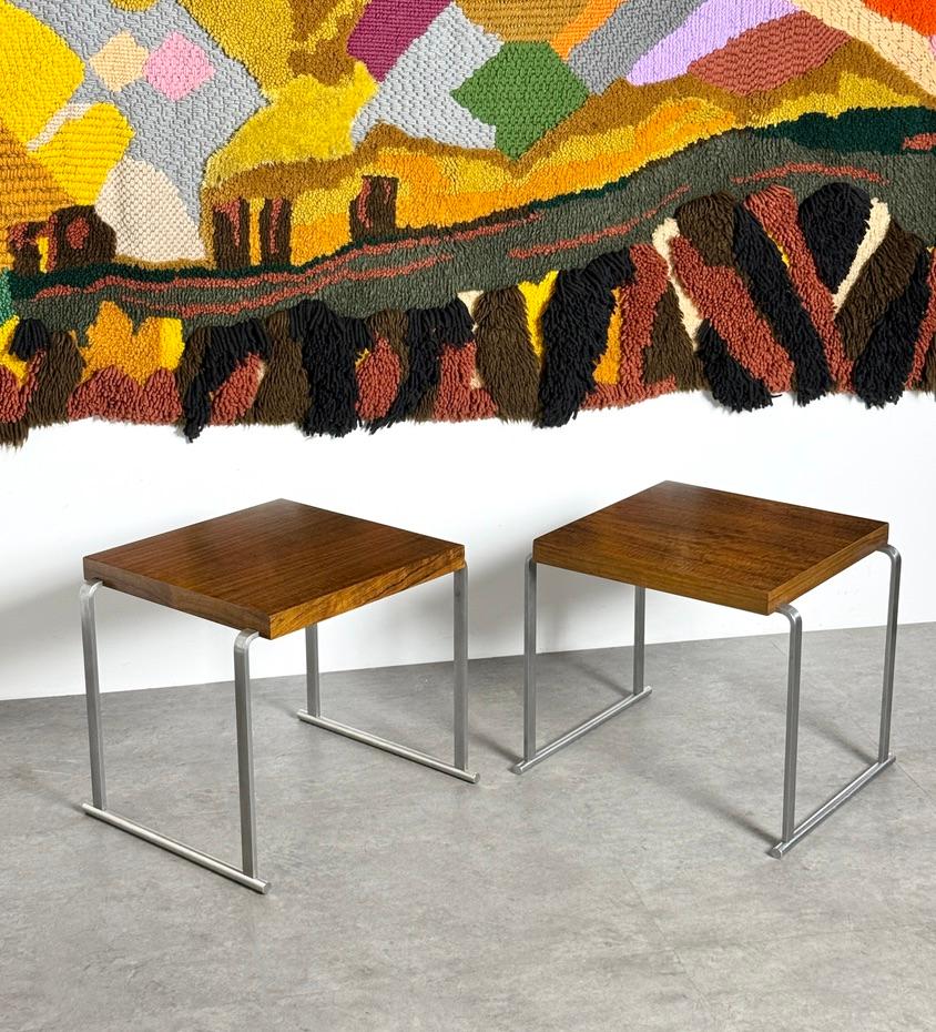 A rare pair of side tables designed by Gilbert Rohde for Herman Miller circa 1933

Early modernist design with square tops in East Indian Laurel 
Supported by inset bent steel legs on a sled base

Surfaces have been expertly restored to original
