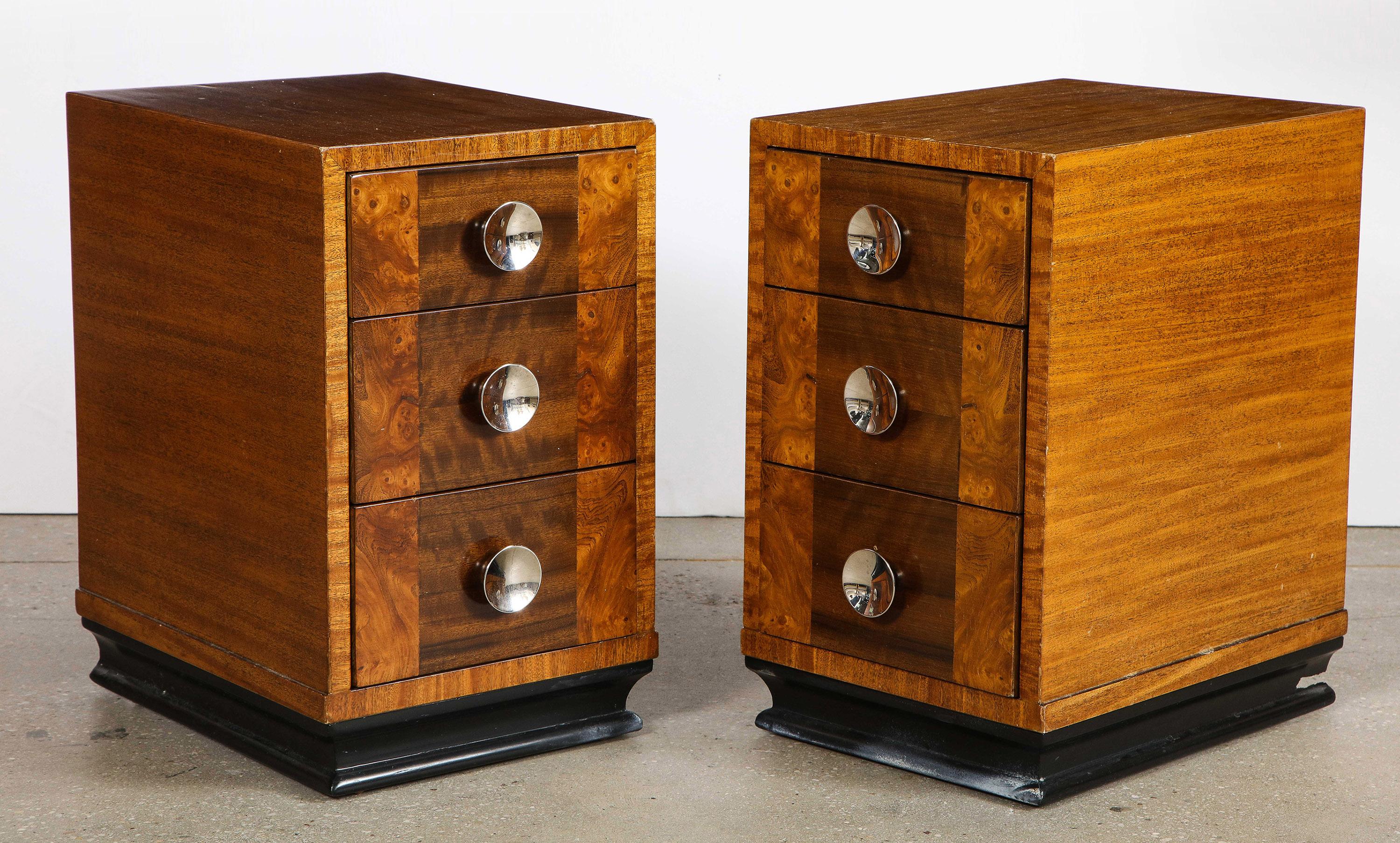 The three drawer nightstands of book matched mahogany, walnut and burled Carpathian elm with nickel pulls.