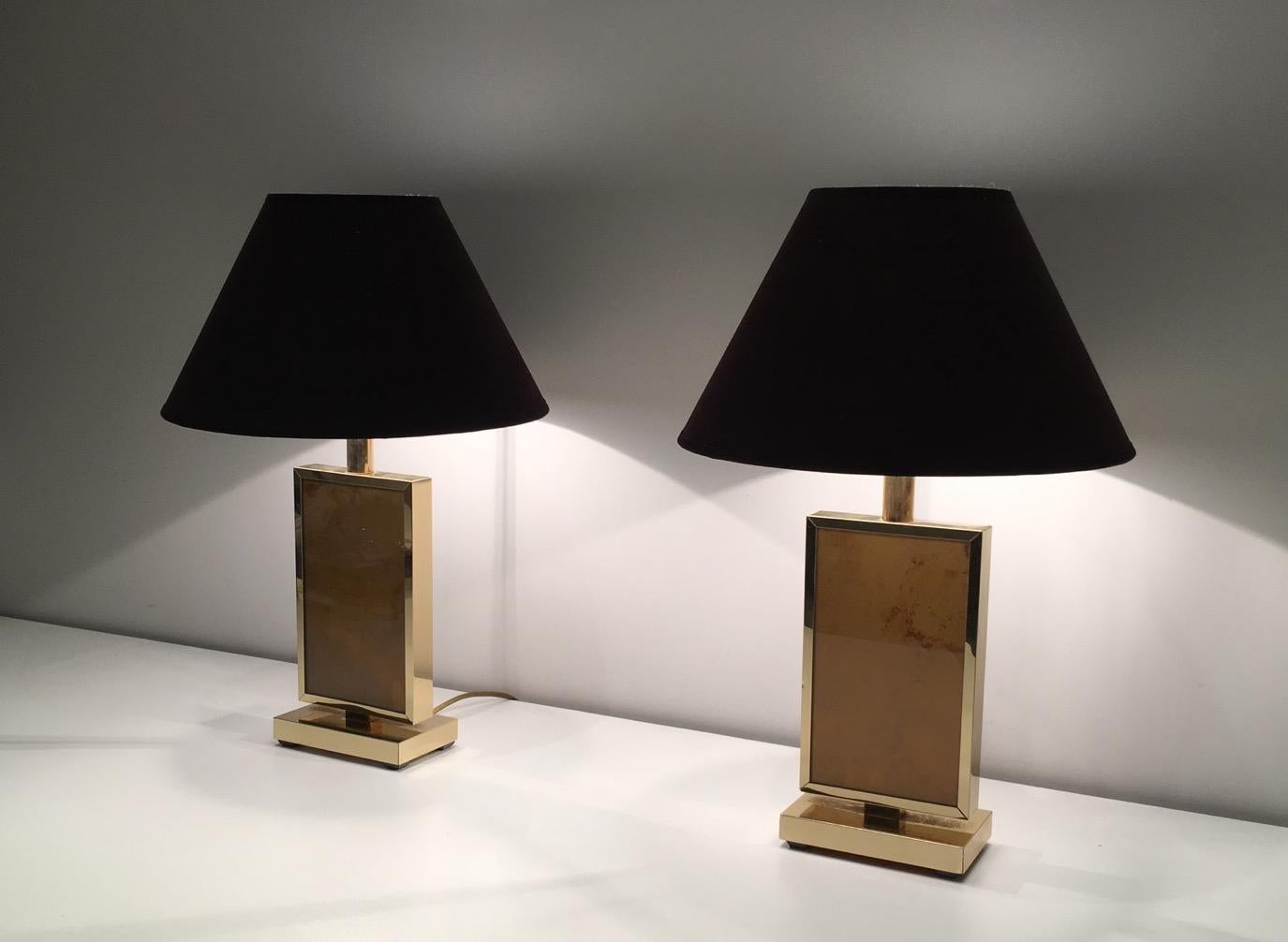 This pair of lamps is made of gilt metal with a nice oranheish decor on each side. These table lamps are very decorative. This is a French work in the style of famous Italian artist Aldo Tura, circa 1970.