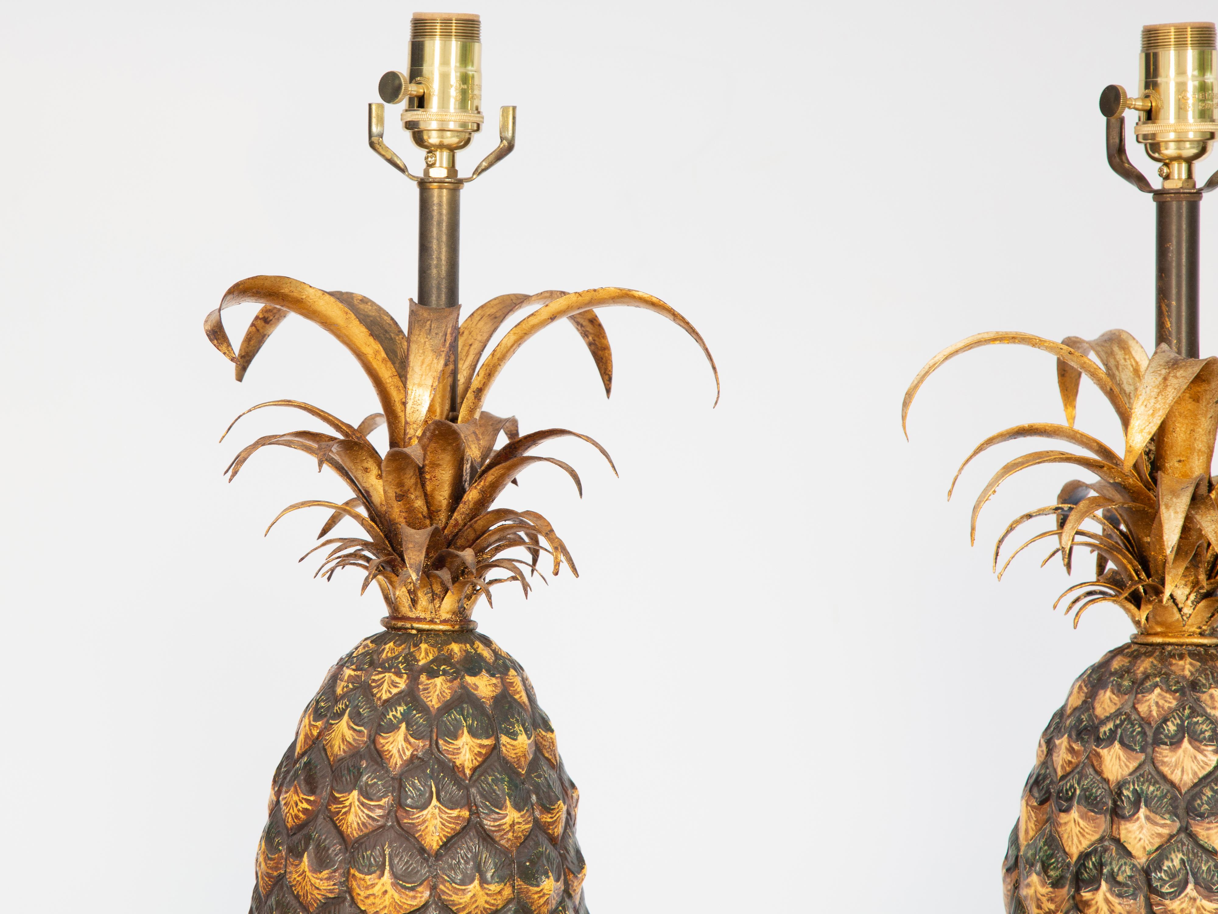 Pair of lamps, by Warren Kessler, of painted and gilded metal formed as pineapples, raised on convex. tapering, square plinth bases.

Height to Socket: 28.25 in
Height to Top of Pineapple: 23 in

Stock ID: D3892