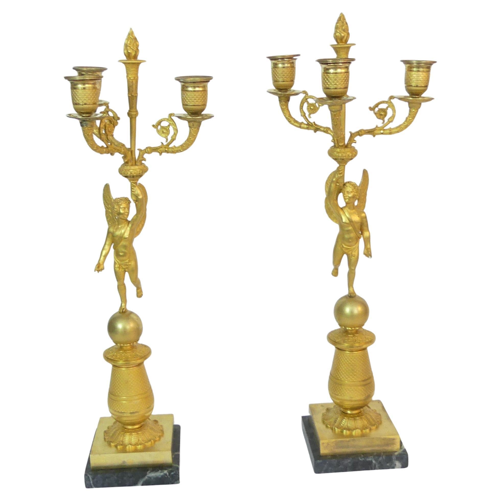 Pair of gilded Empire candelabra with five lights, made of high-quality bronze For Sale