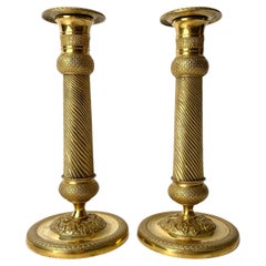 Pair of Gilded French Empire Candlesticks with charming decor from the 1820s