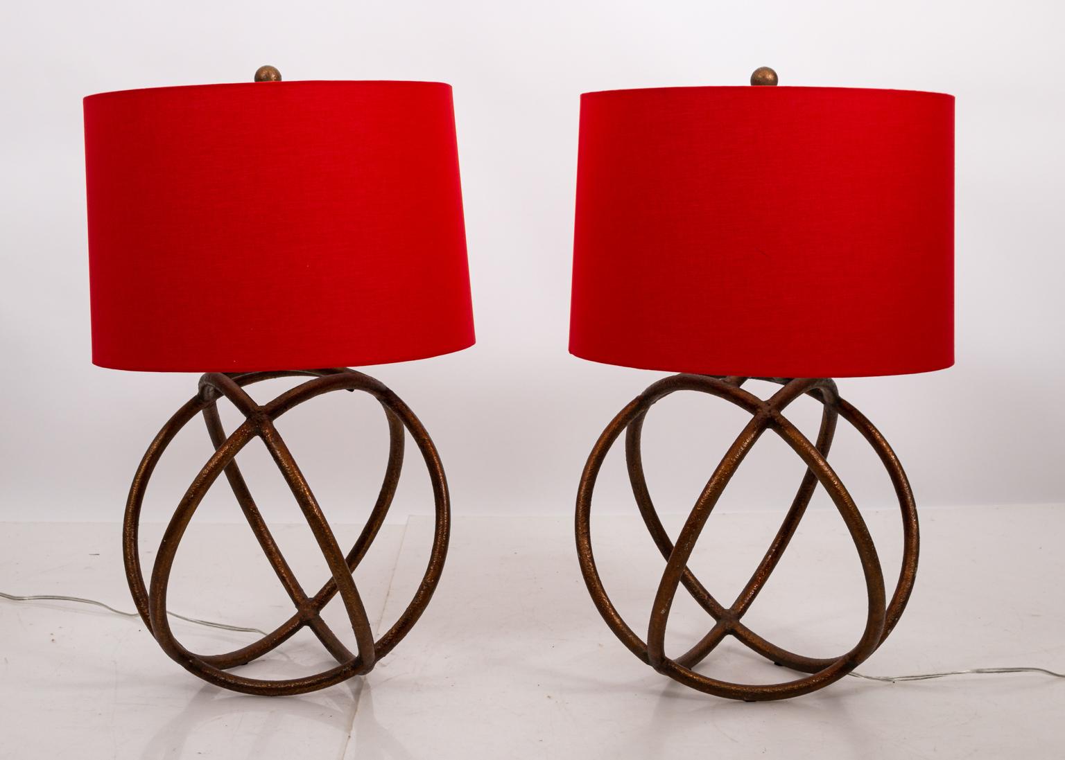 Gilded Iron sphere shaped table lamps in the modern style, circa 20th century. Please note of wear consistent with age. Red shades are not included.