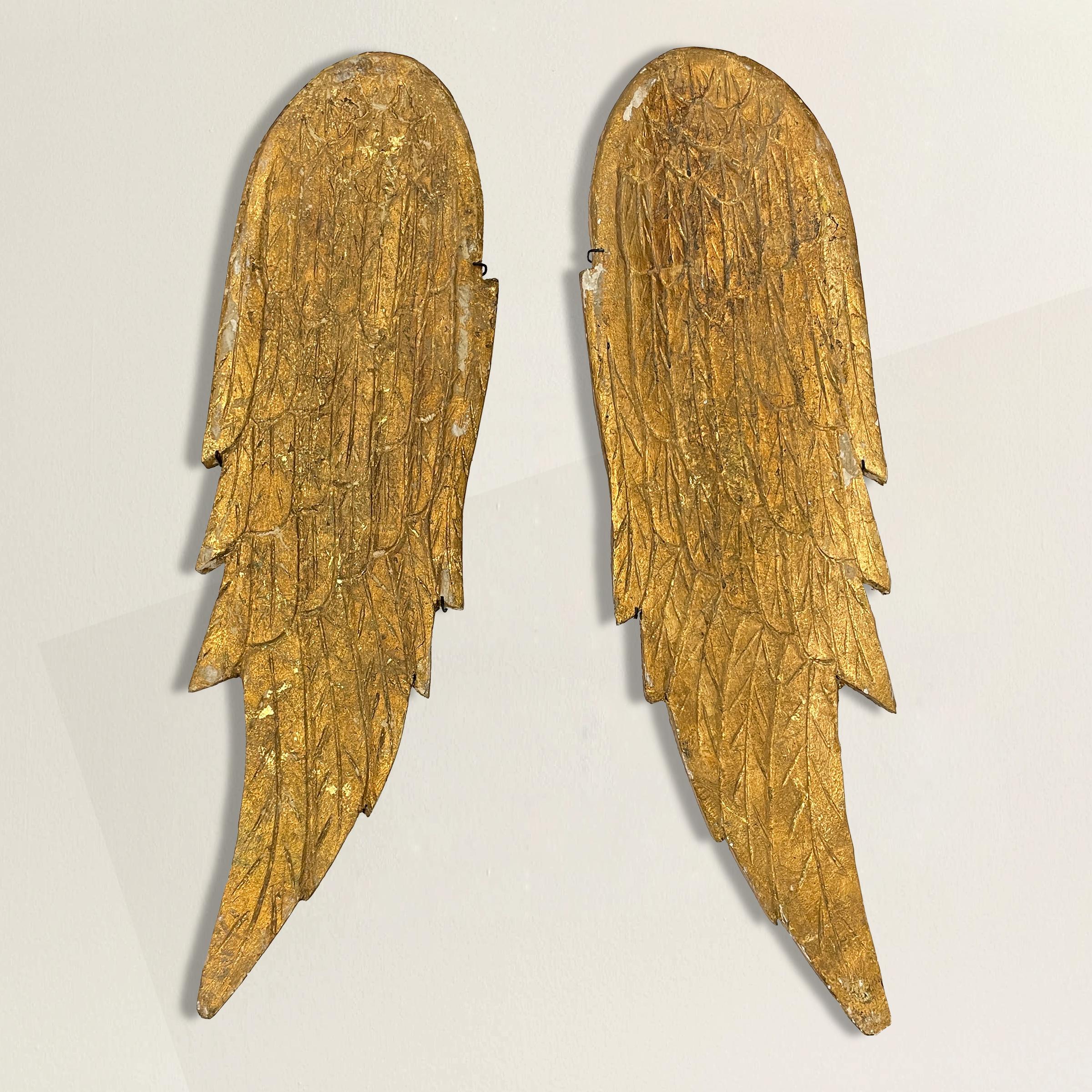 A special pair of 20th century hand-carved wood angel wings with a gold leaf finish, and each mounted on a custom steel wall mount. They are mounted individually, so they may be displayed separately and positioned in any orientation desired.