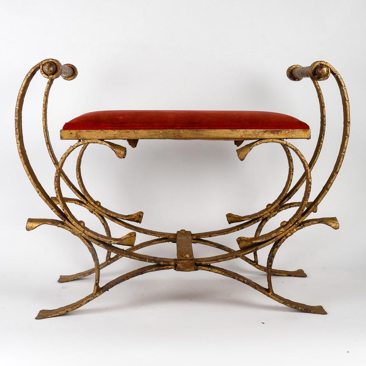 Pair of Gilded Wrought Iron Curule Stools and Seats, Early 20th Century.

Pair of 1930s-1940s wrought iron and gilt curule stools, red velvet seat, Art Deco style.  
W: 71cm, H: 54cm, D: 39cm