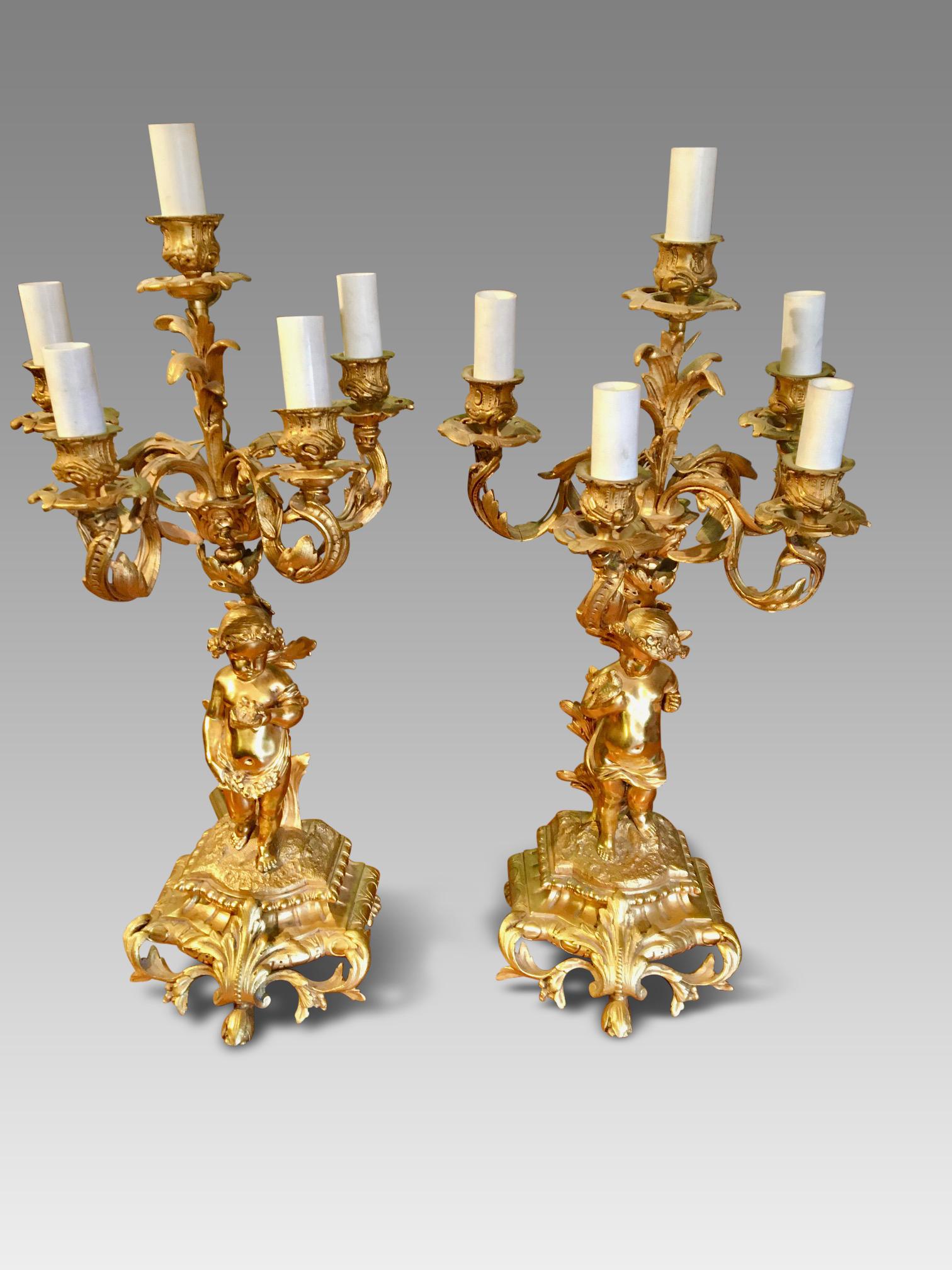 Fine quality pair of 5 branch gilded candelabra in excellent condition. English circa 1930s.
These candelabra are a very good size, standing 20 ins high with a circumference size of 10 ins.
The design and craftsmanship is superb with both cherubs