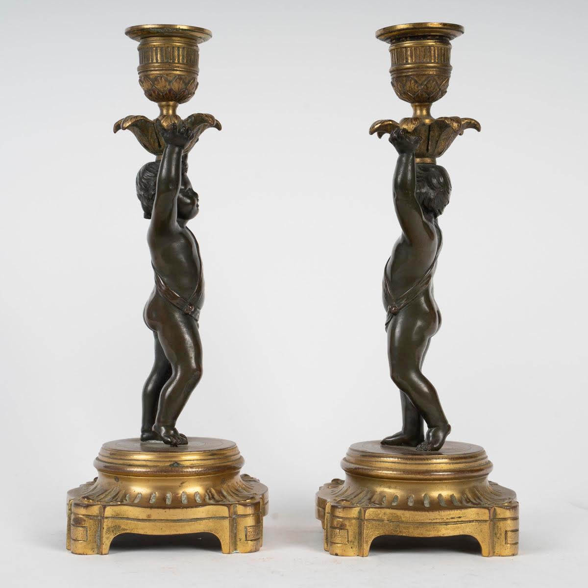 Pair of gilt and patinated bronze candlesticks, 19th century, Louis XVI style.

A pair of Louis XVI style candlesticks, 19th century in gilt and patinated bronze.
H: 23.5cm, W: 8.5cm, D: 8.5cm