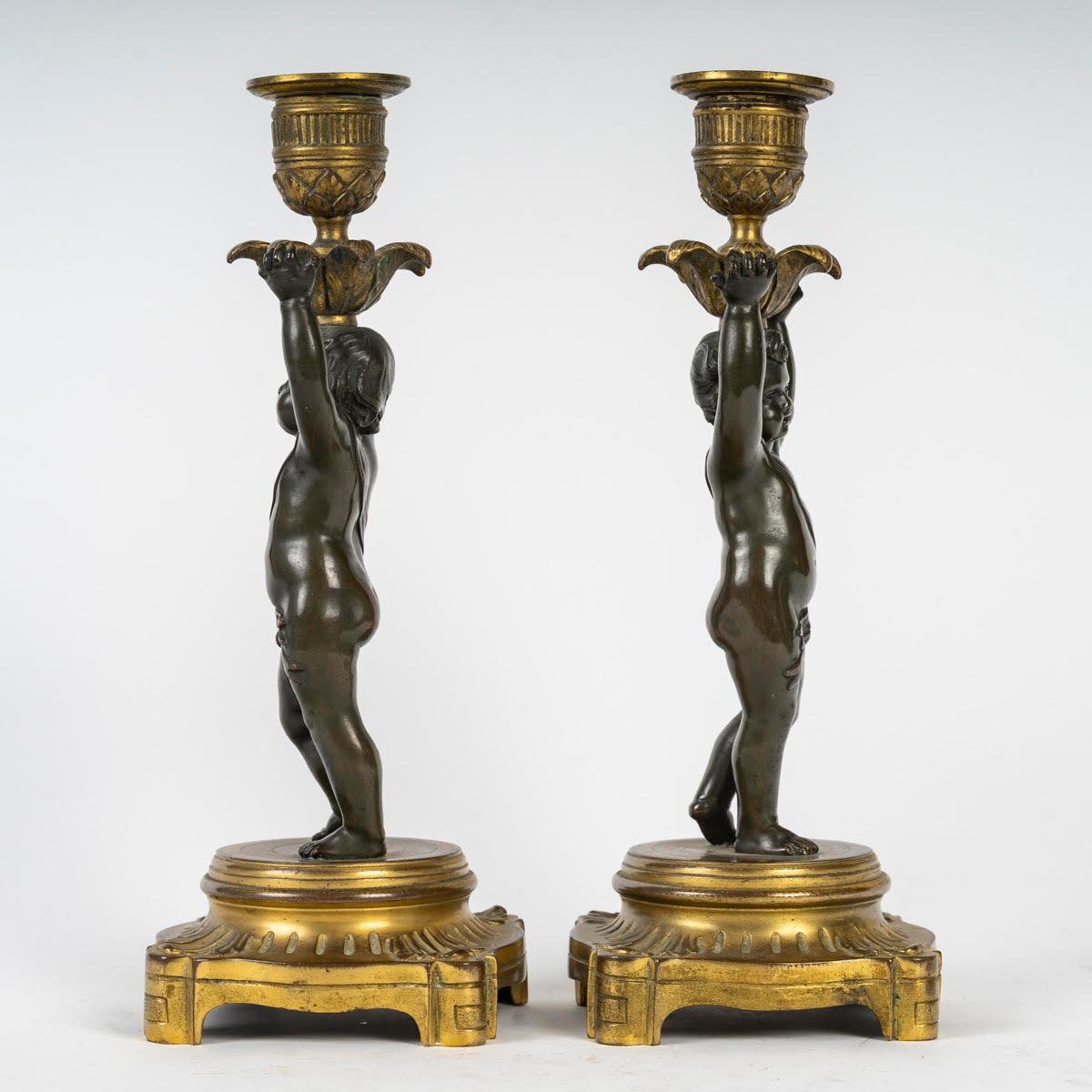 French Pair of Gilt and Patinated Bronze Candlesticks, 19th Century, Louis XVI Style. For Sale