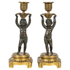 Paire de chandeliers en bronze doré et patiné, 19ème siècle, style Louis XVI.
