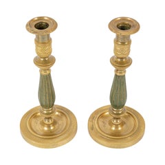 Coppia di candelabri in bronzo patinato e dorato